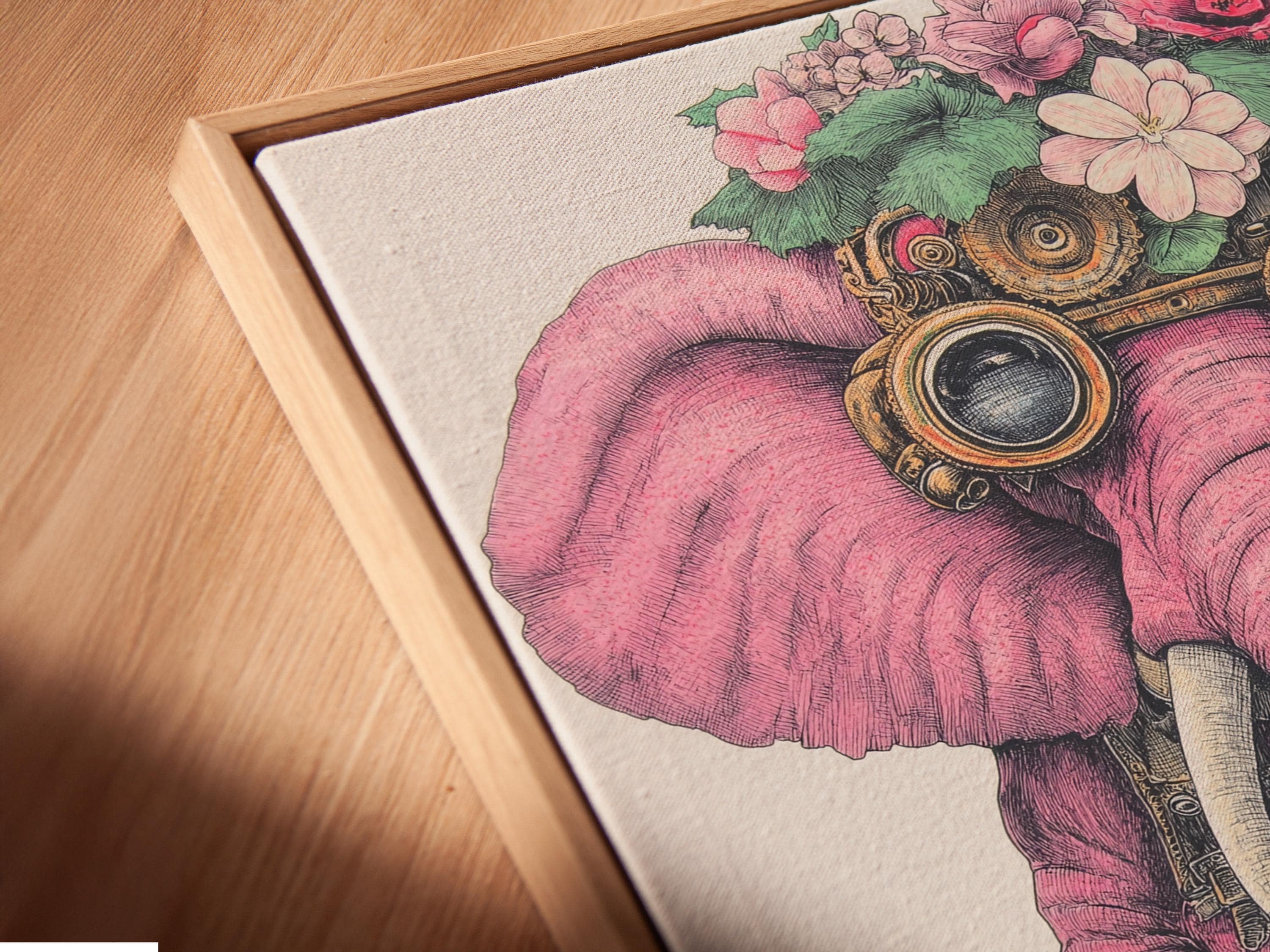 Wall art mockup showing a framed pink elephant illustration with steampunk goggles