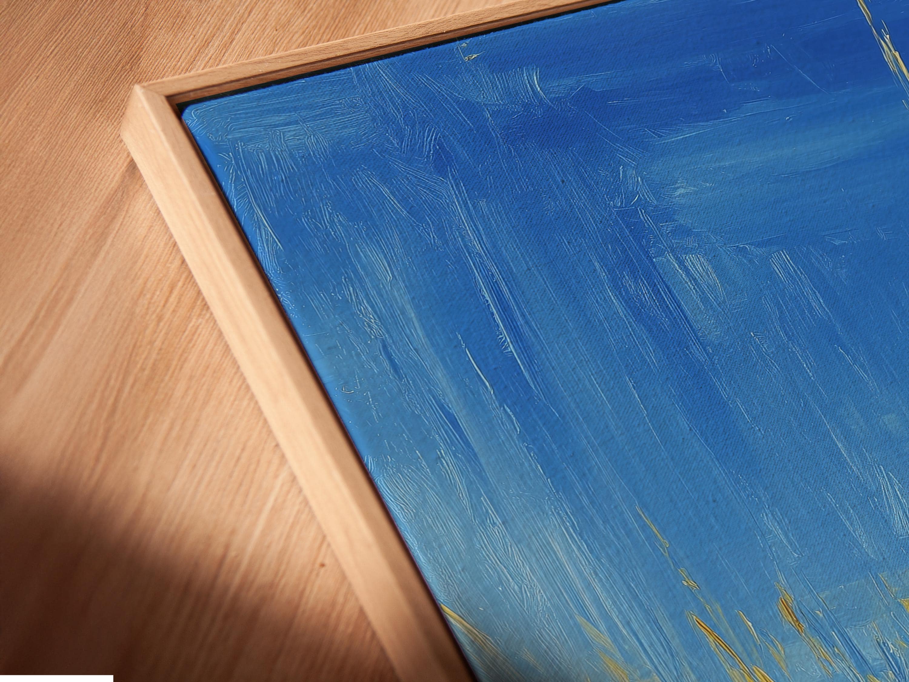 Framed artwork featuring a woman on a swing against a bright blue sky, with yellow grass