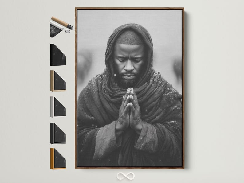 Monochrome portrait of a hooded figure praying with clasped hands