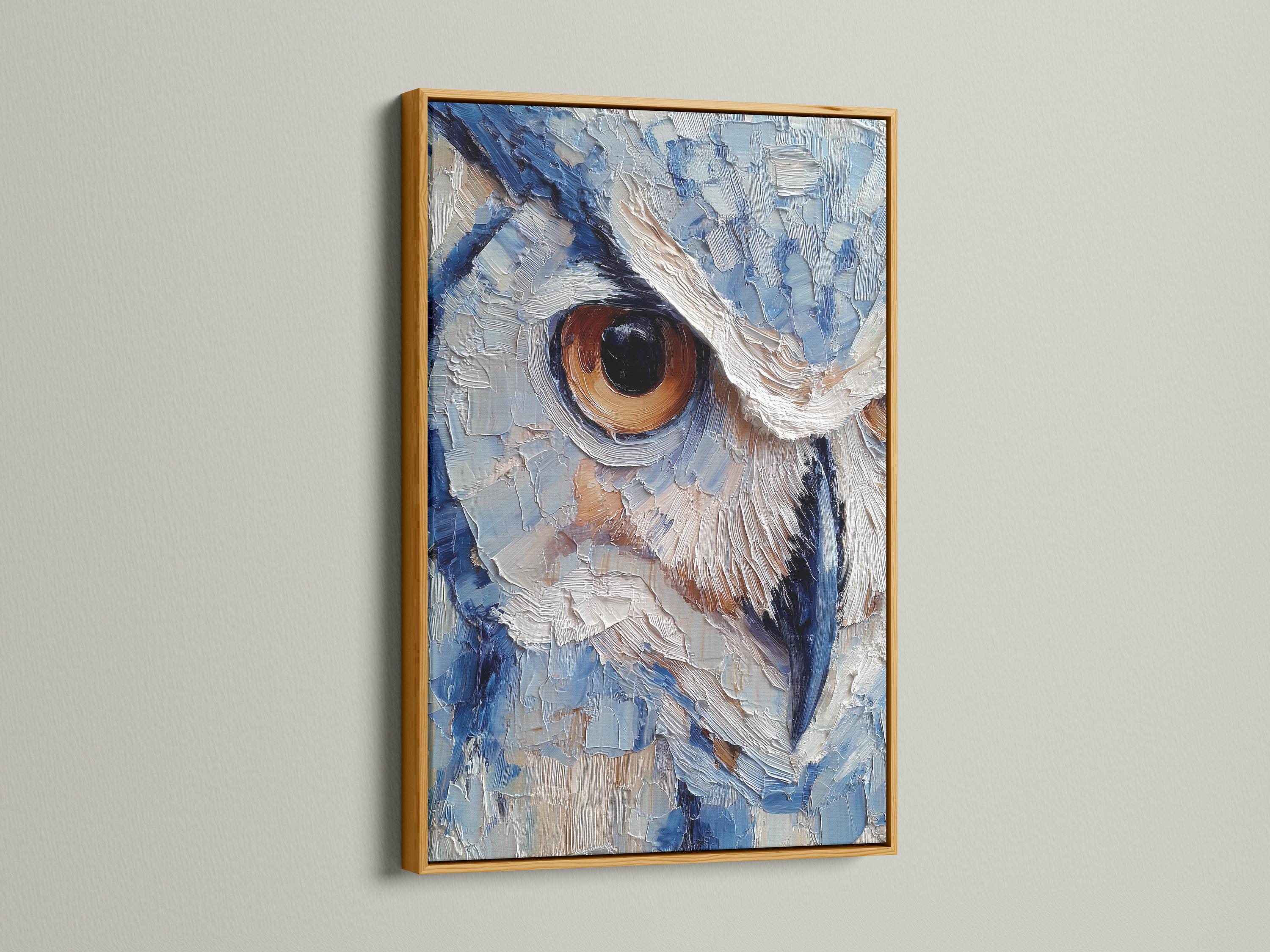 Room scene with a framed blue owl painting above a desk where a person writes in a book
