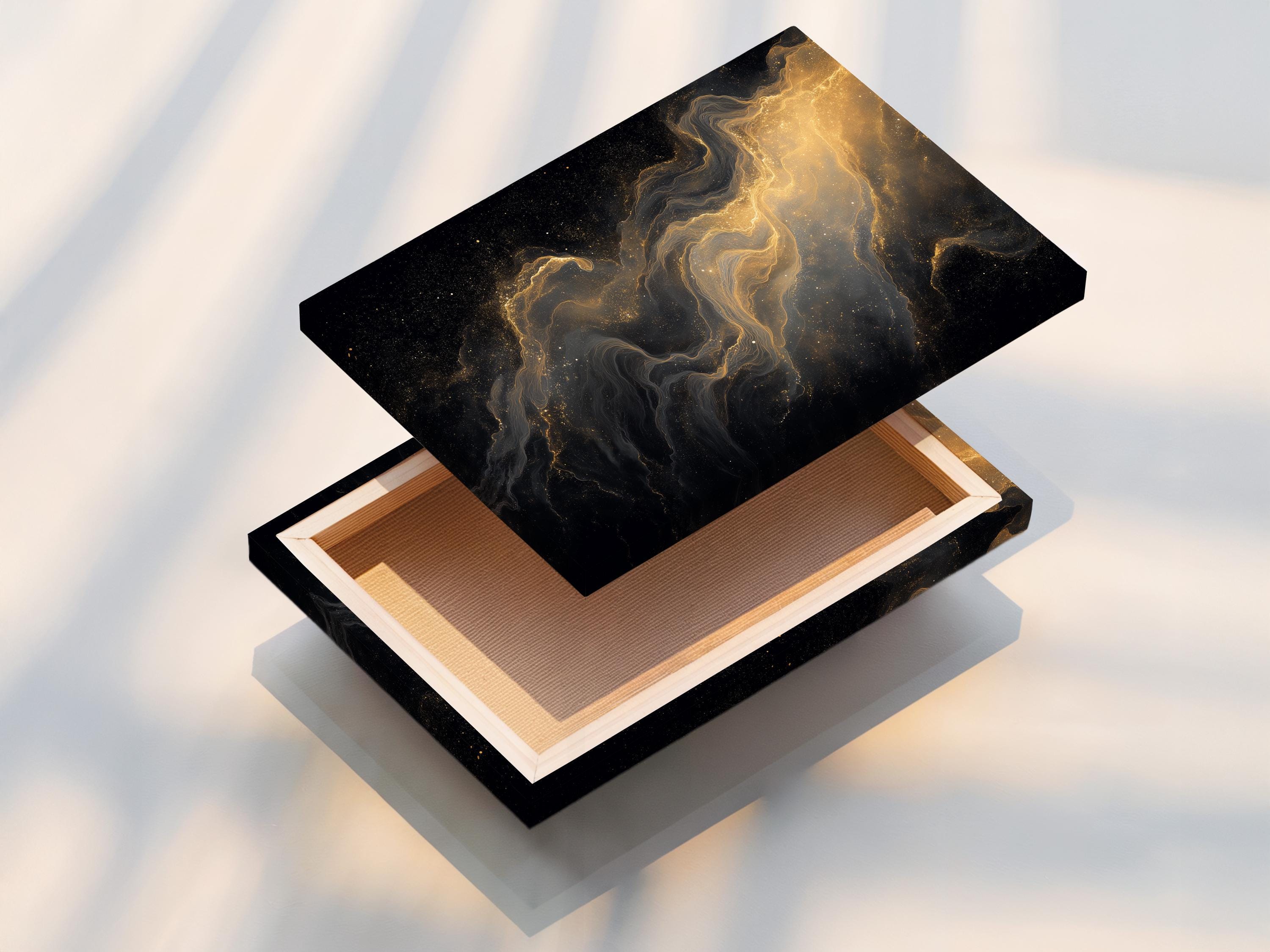 Room mockup showing a framed black and gold abstract artwork with gold dust trails