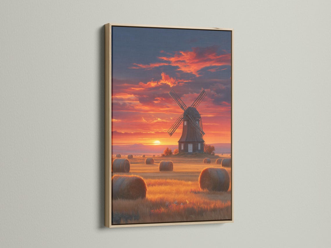 Windmill in a countryside landscape under a glowing sunset sky with hay bales detail view