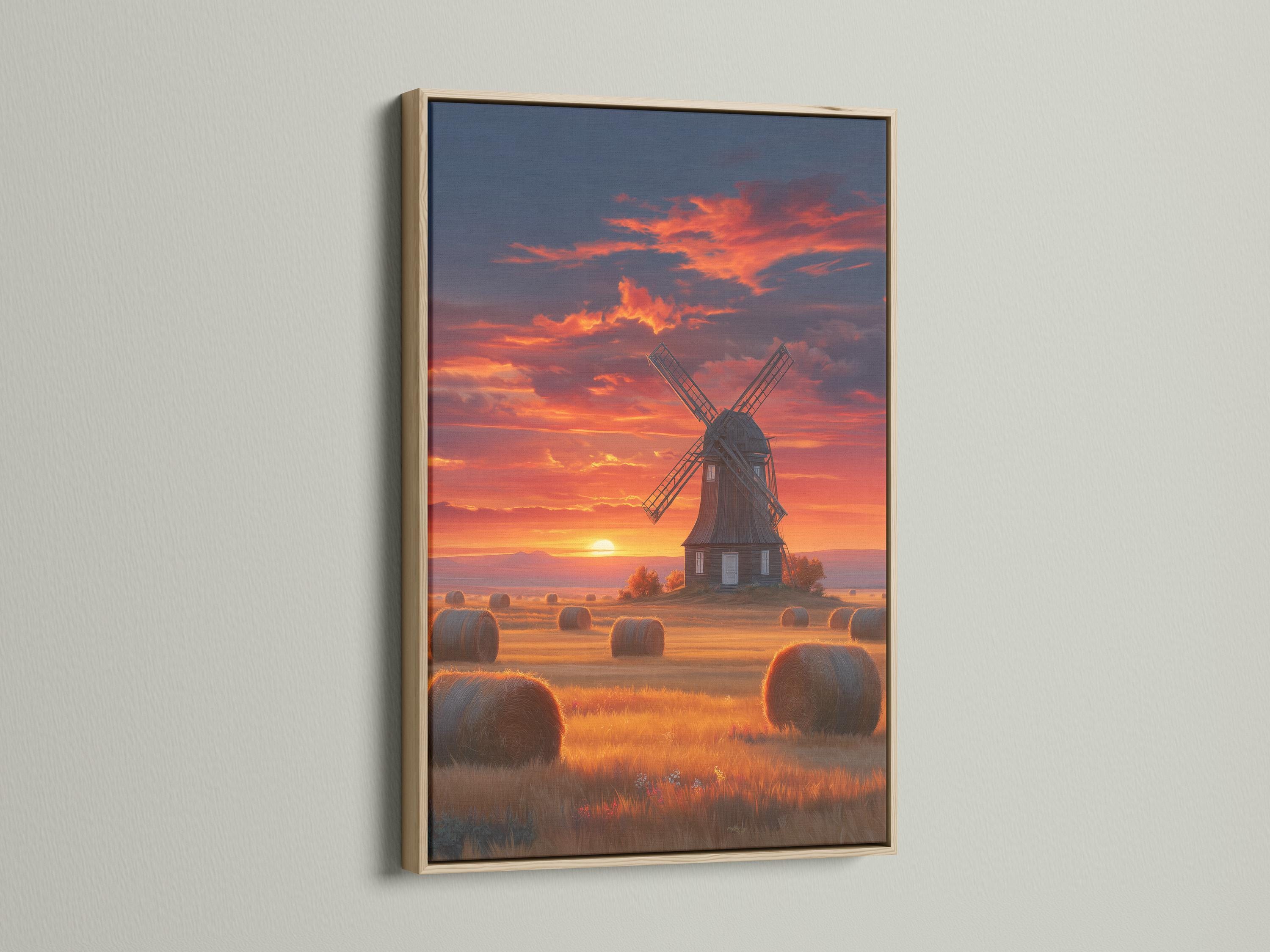 Windmill in a countryside landscape under a glowing sunset sky with hay bales detail view