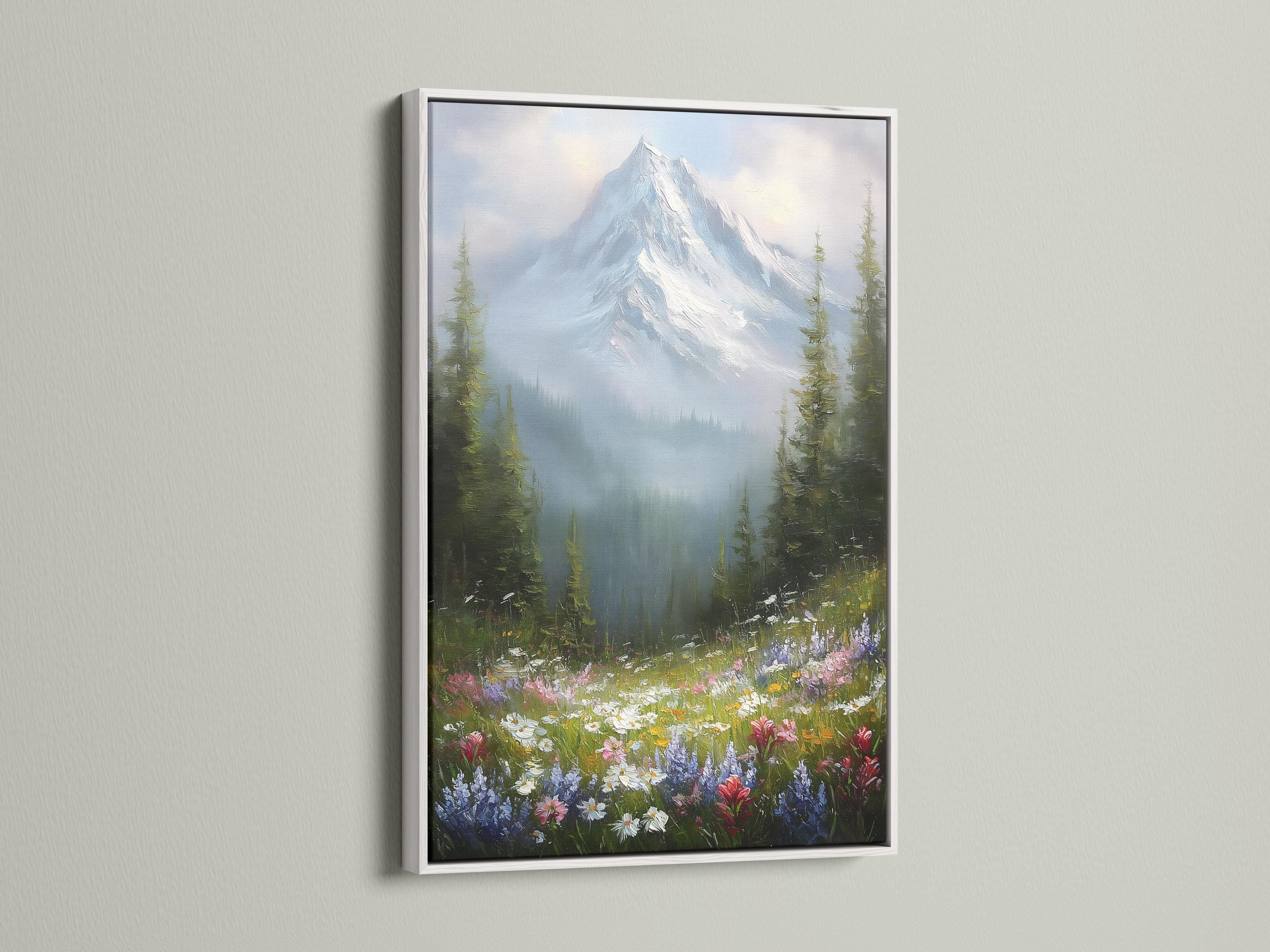 Wall mockup featuring a framed snowy mountain landscape with wildflowers and forest trees