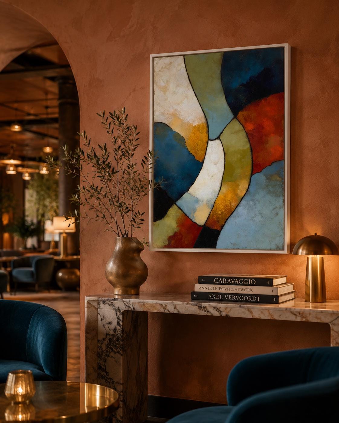Man sitting on a sofa in a room, with an abstract geometric artwork on the wall