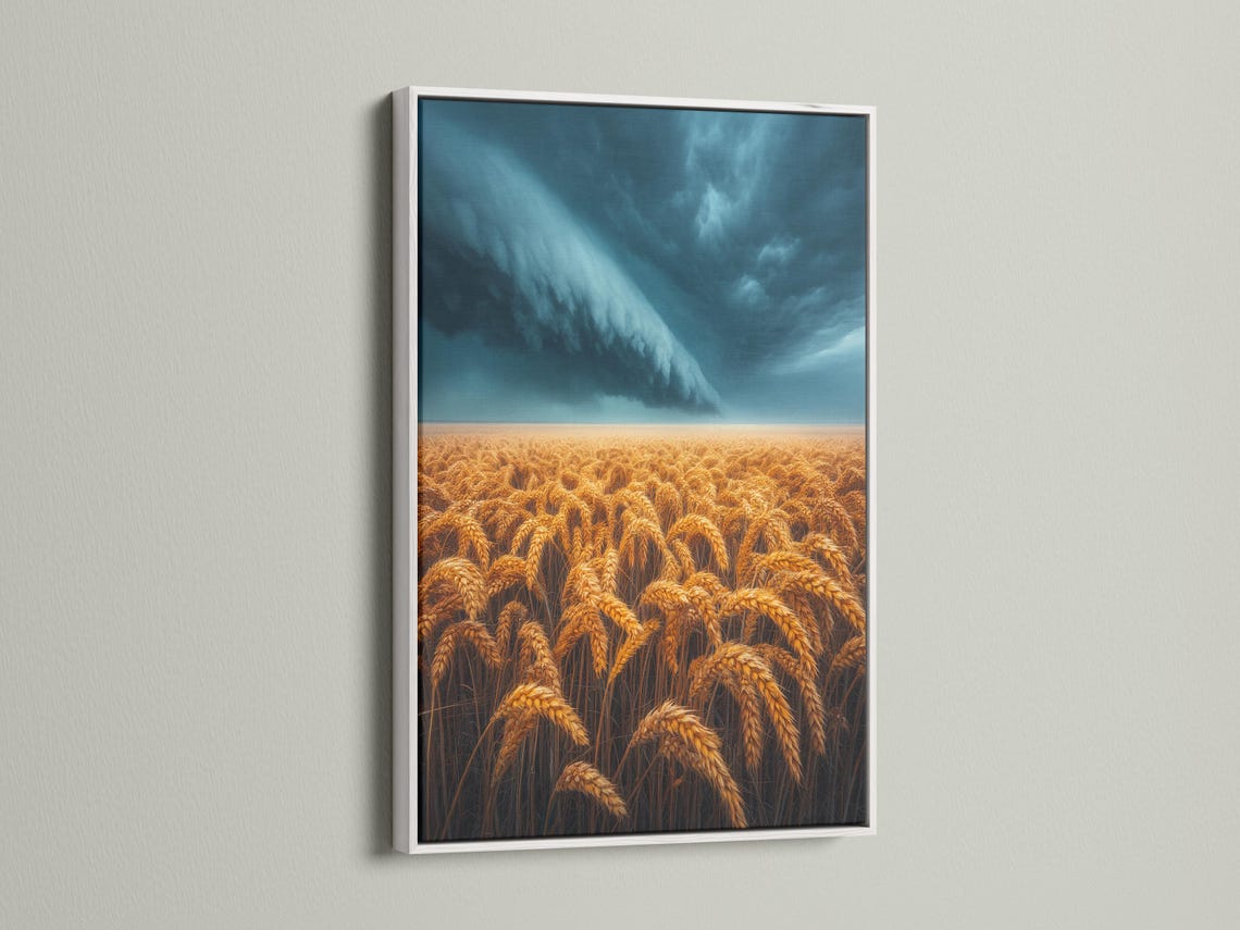 Golden wheat field under a stormy blue-grey sky with sweeping clouds and a bright horizon band detail view