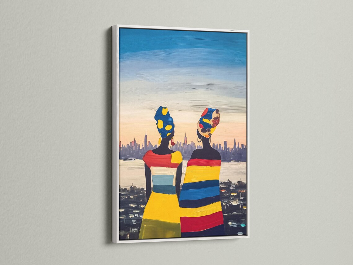 Framed artwork mockup showing two stylised women figures in bright colours with a city skyline background