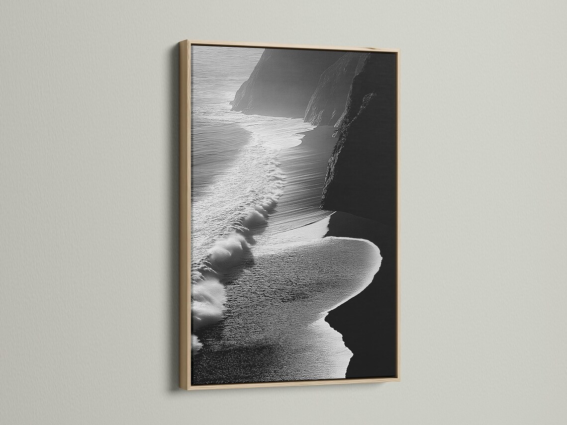A monochrome seascape shows foamy wave textures breaking along a shoreline, with dark cliff-like shapes framing the scene detail view