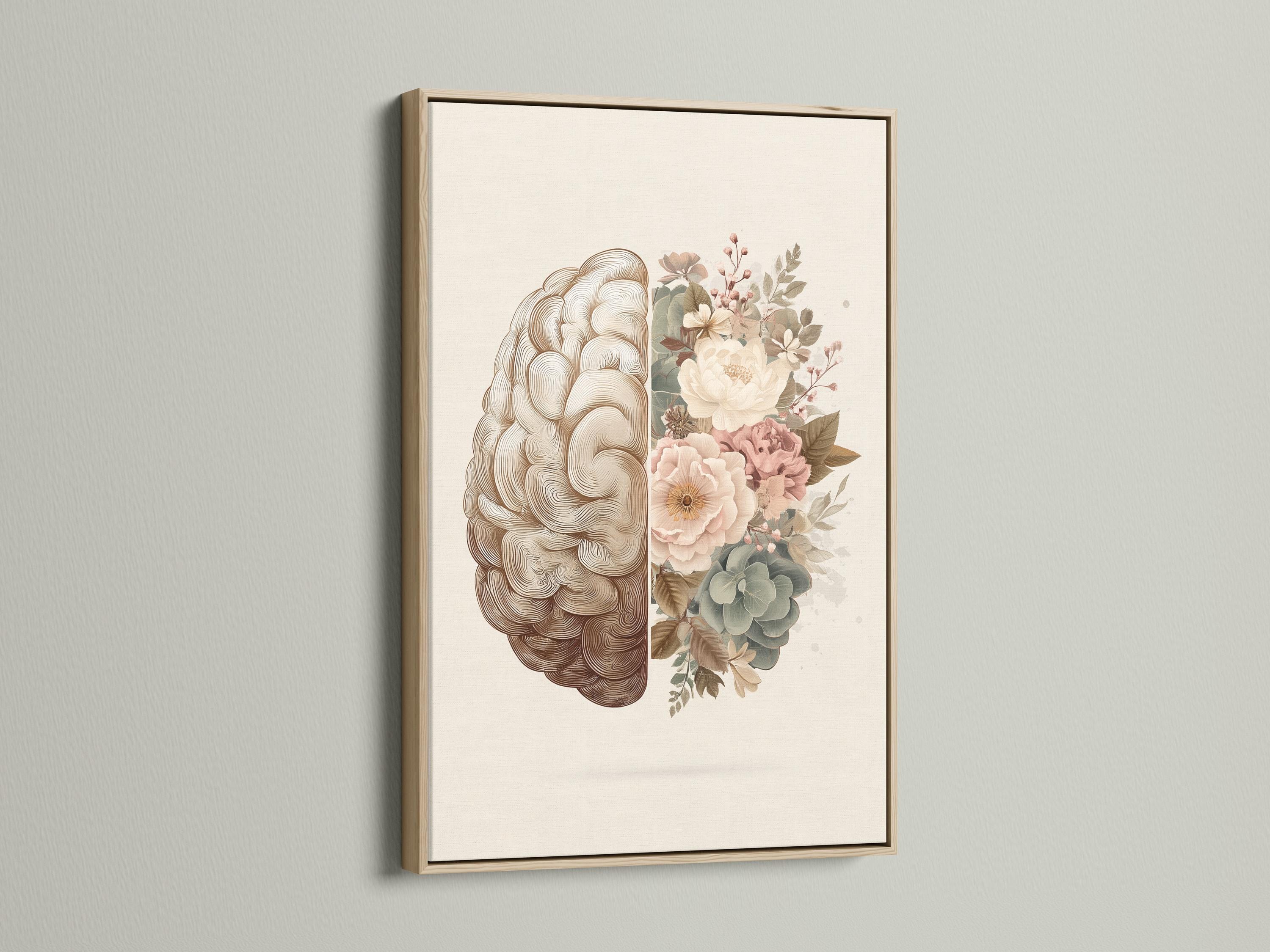 Person reading beside a framed split brain and floral artwork on a floor in a softly lit room