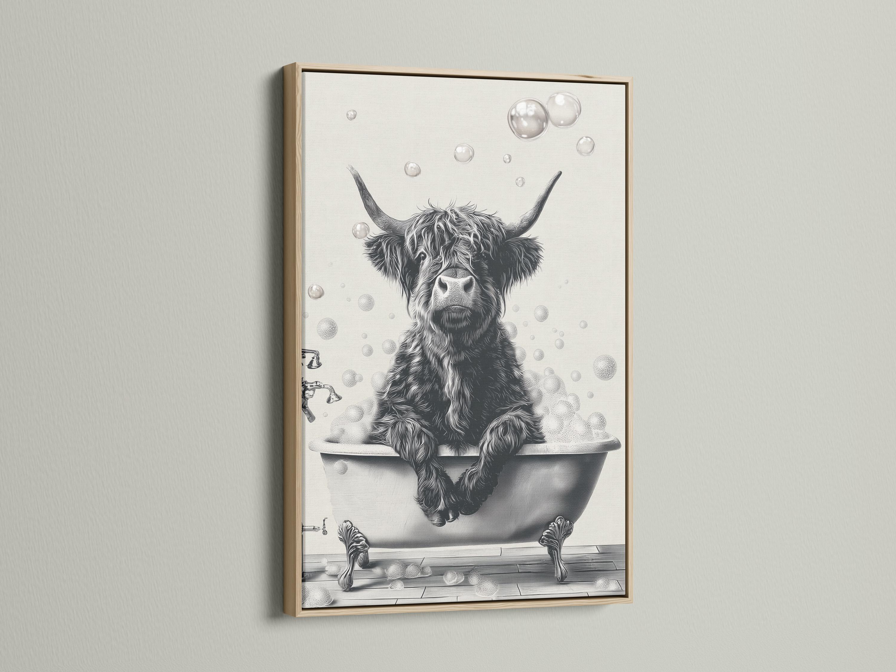 Woman holding a mug standing beside a framed monochrome highland cow bathtub artwork