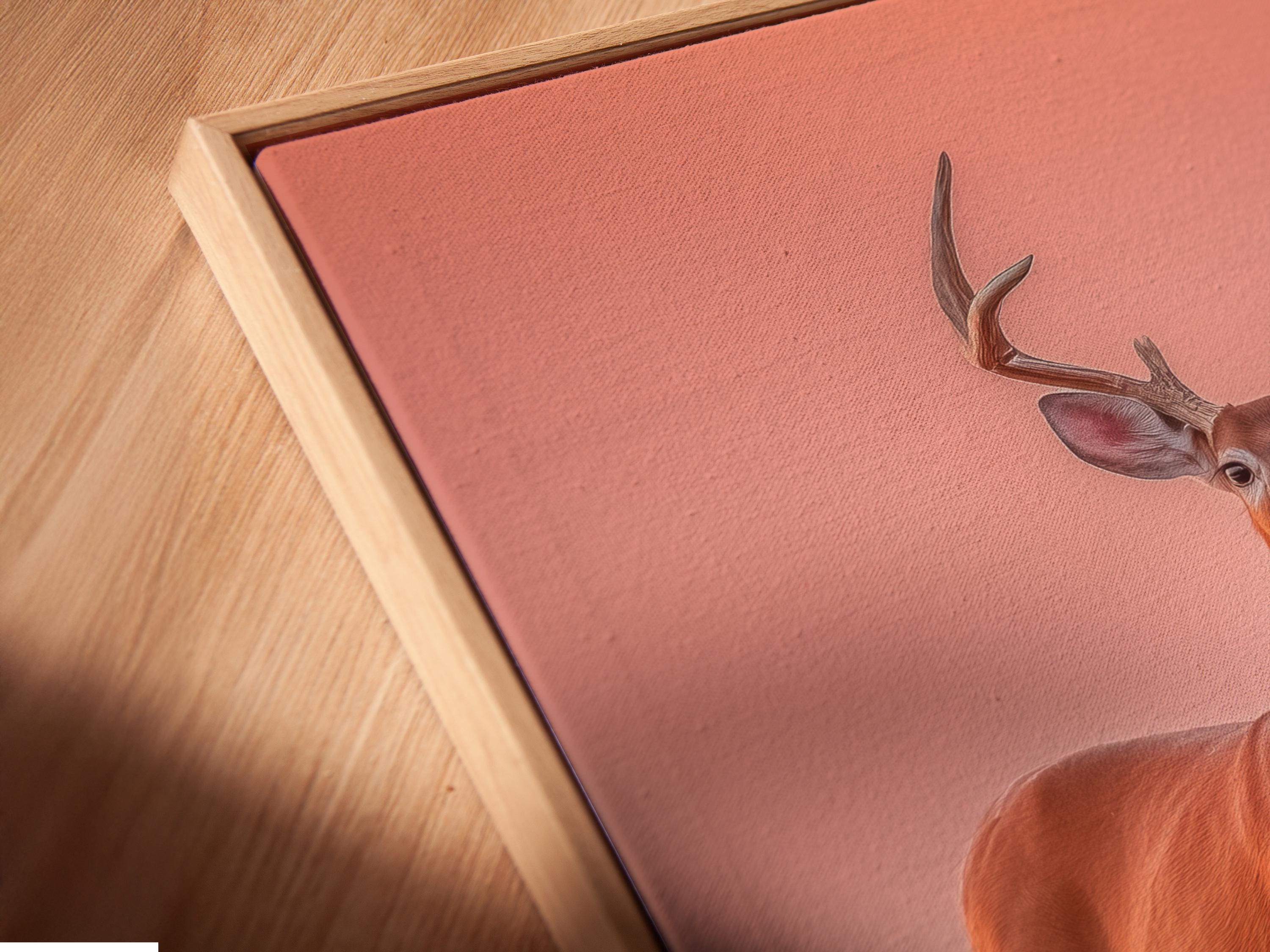 Deer portrait with tall antlers against a blush pink background and pink blossoms detail view
