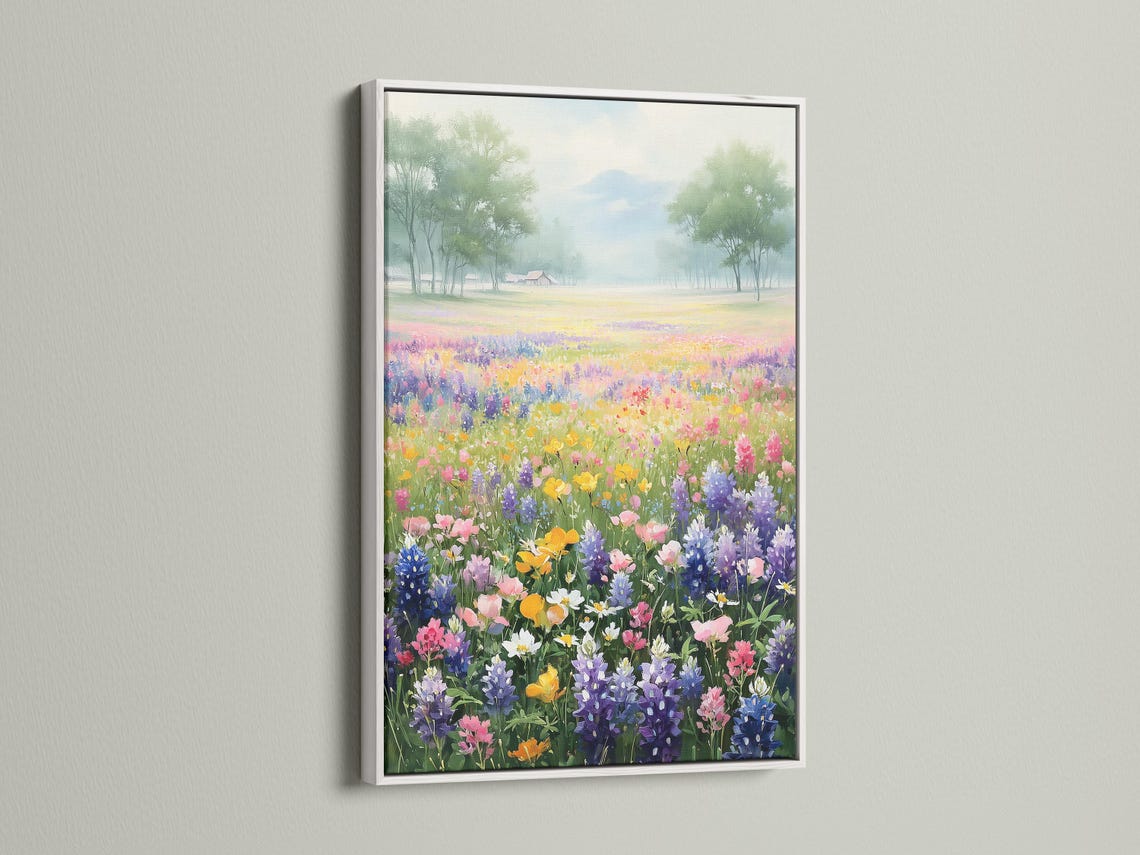 Pastel wildflower meadow with colourful flowers in the foreground and misty trees in the distance detail view