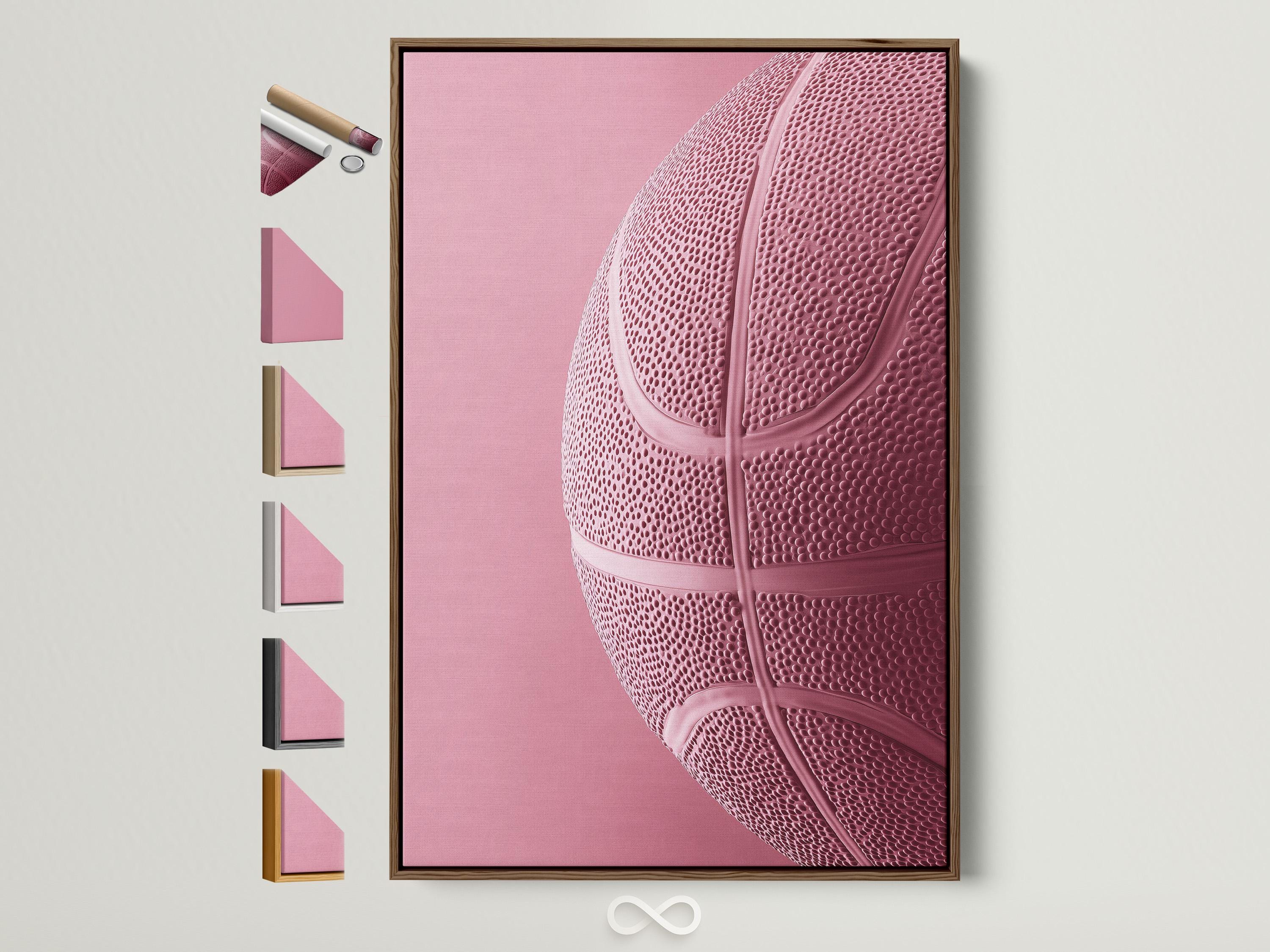Woman sitting on a sofa beside a framed bubblegum pink basketball artwork