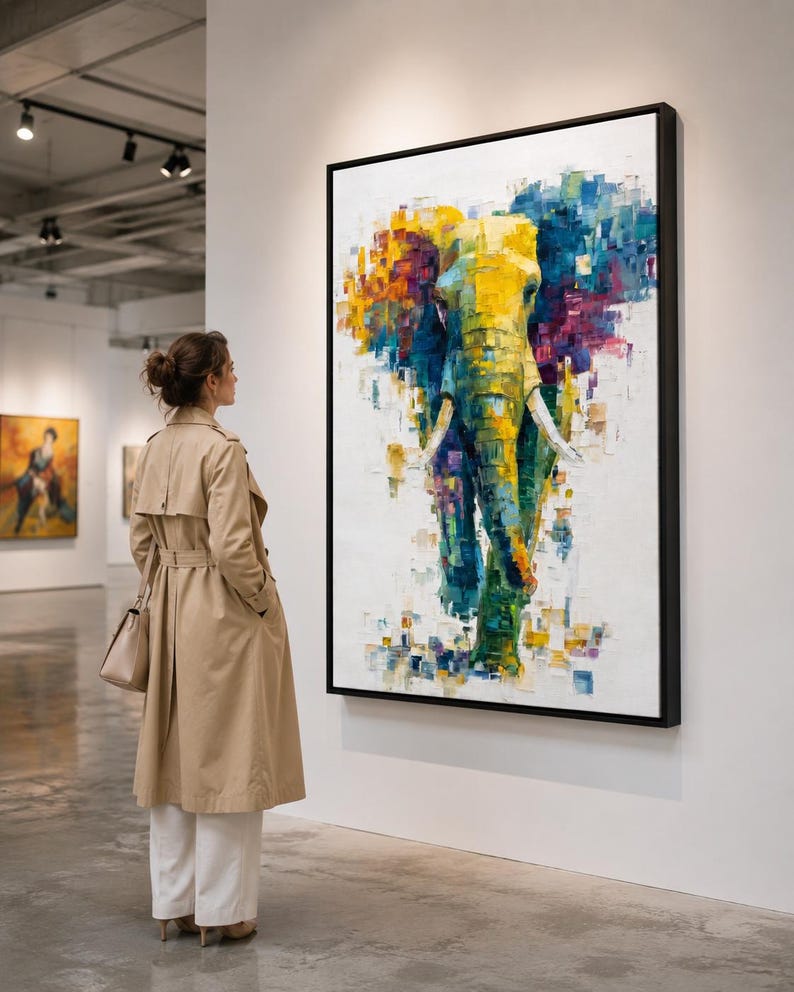 Abstract elephant artwork with layered teal, yellow and magenta colour blocks on an off-white background