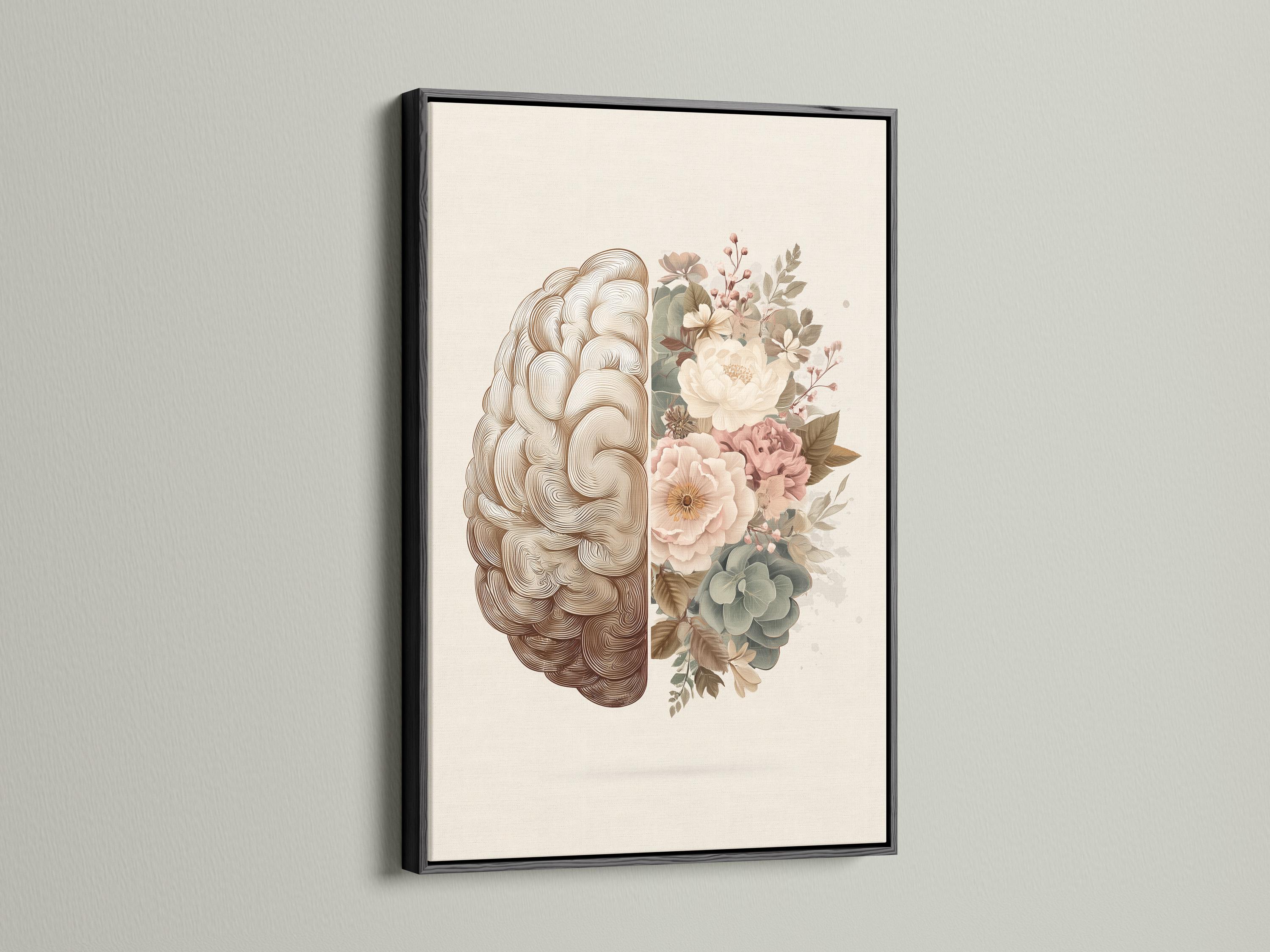Person reading beside a framed split brain and floral artwork on a floor in a softly lit room