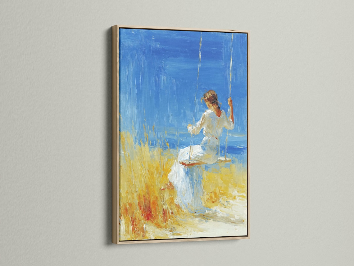 Framed artwork featuring a woman on a swing against a bright blue sky, with yellow grass