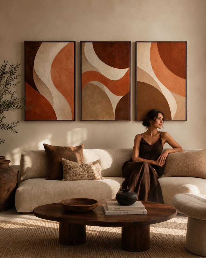 Three terracotta and beige abstract panels with curved layered shapes