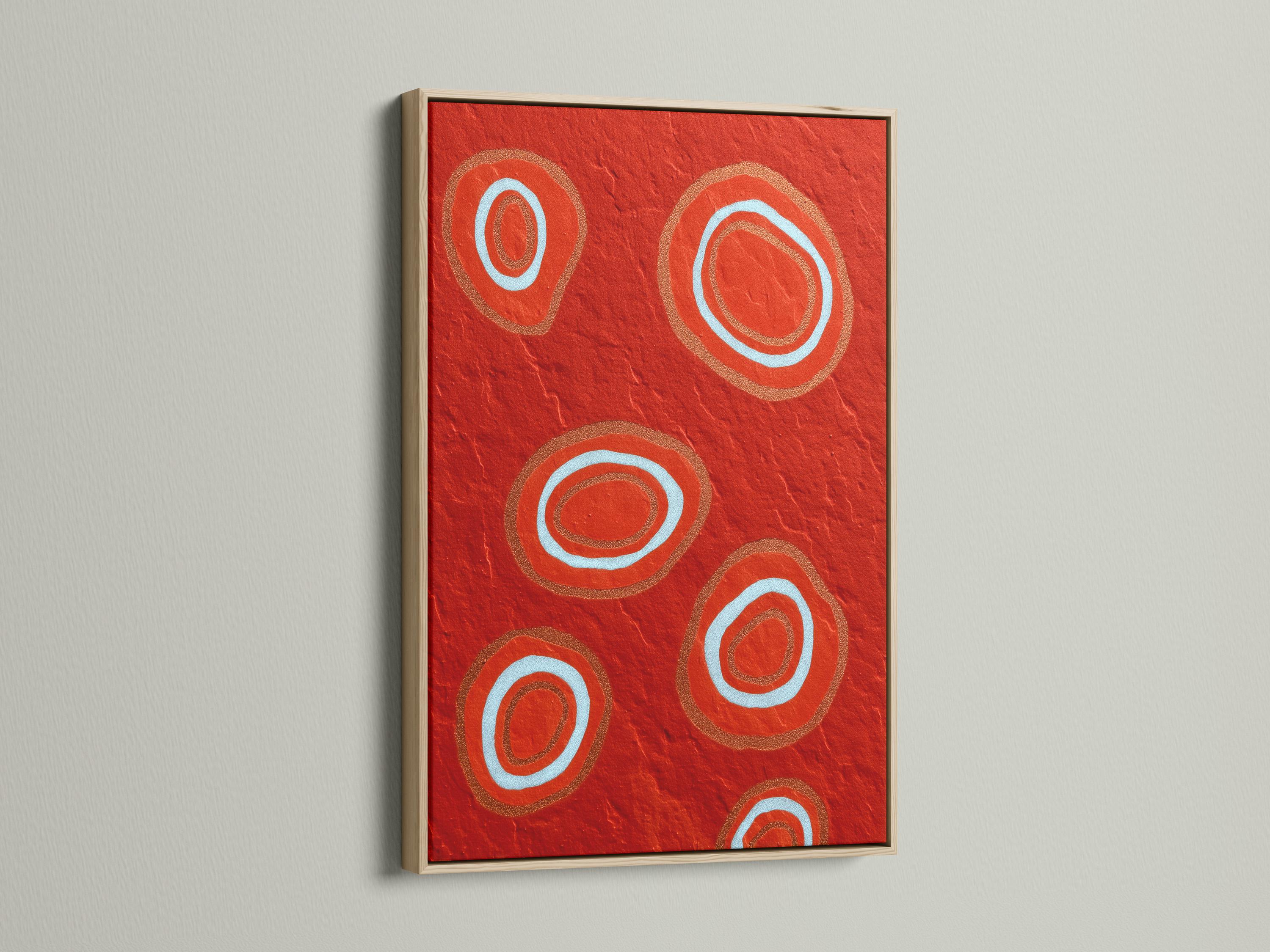 Room mockup showing a red abstract artwork with concentric circle motifs in pale blue and copper tones
