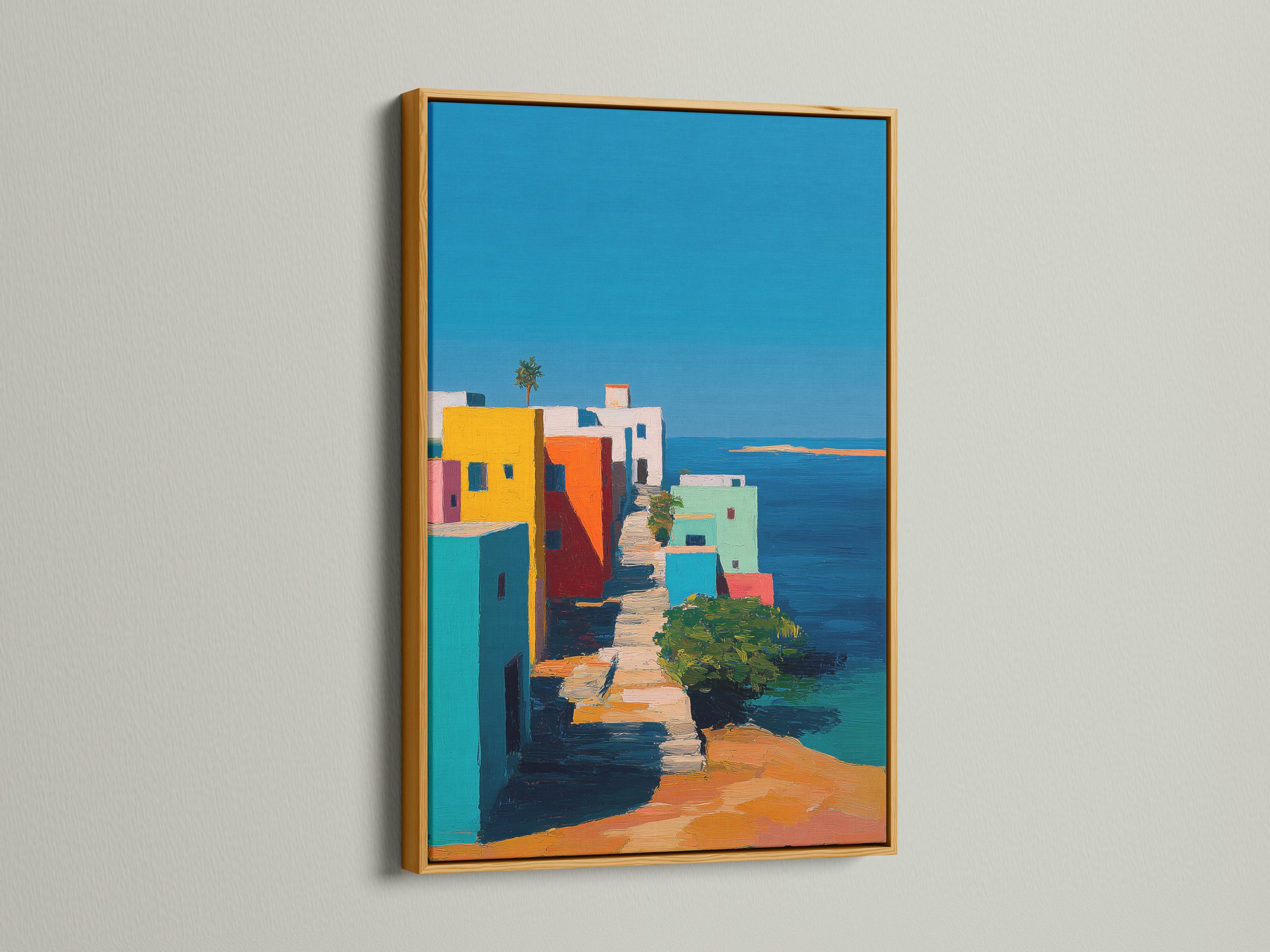 Wall mockup showing a framed coastal village artwork with colourful buildings and blue sky