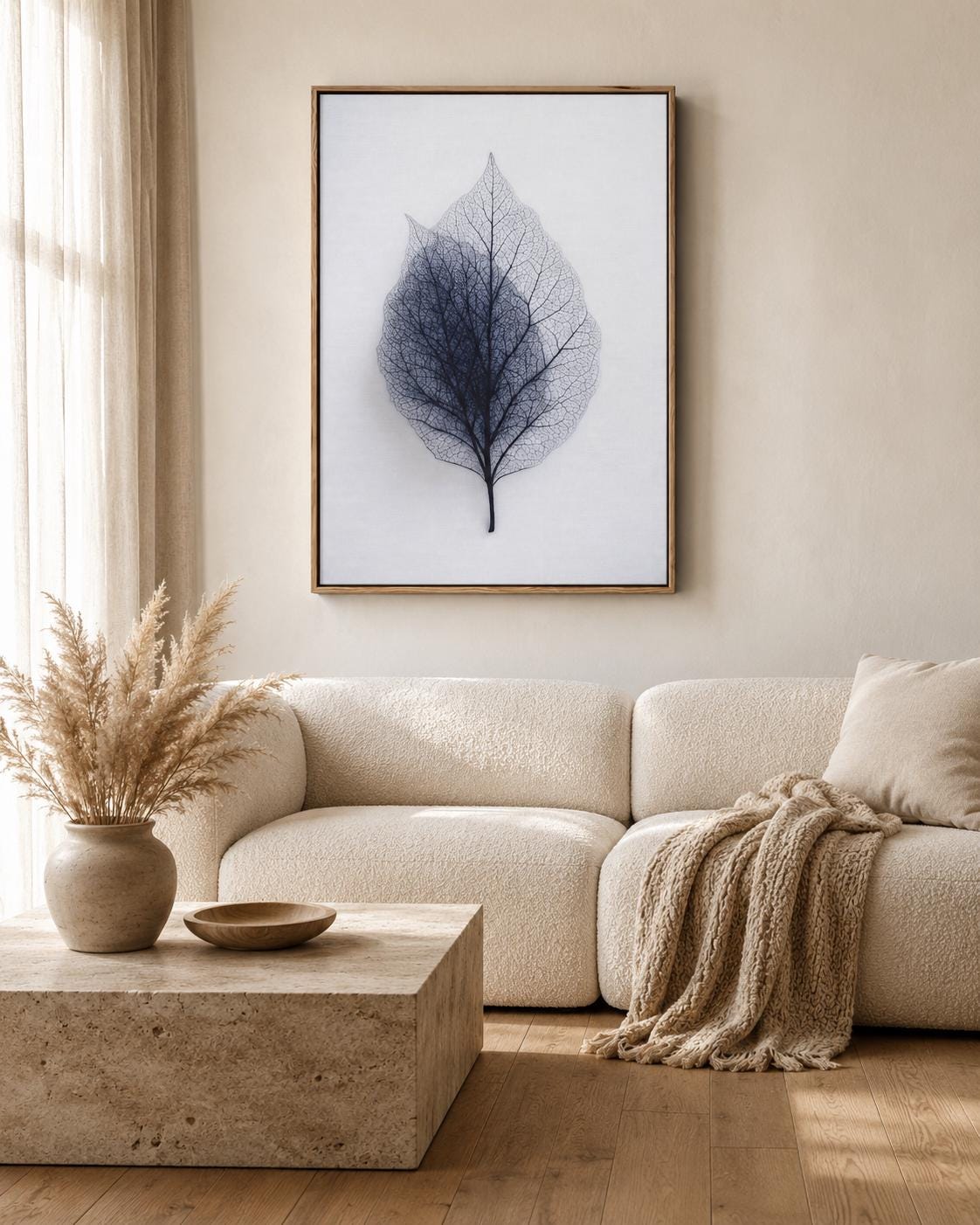 A person looking at a framed leaf skeleton wall artwork in a bright room