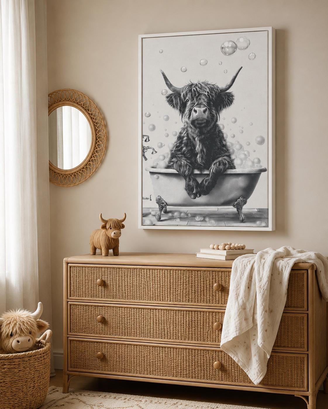 Woman holding a mug standing beside a framed monochrome highland cow bathtub artwork