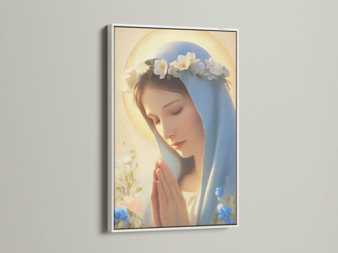 Framed religious portrait on a wall with a bowed robed woman, blue veil, golden halo glow, and clouds