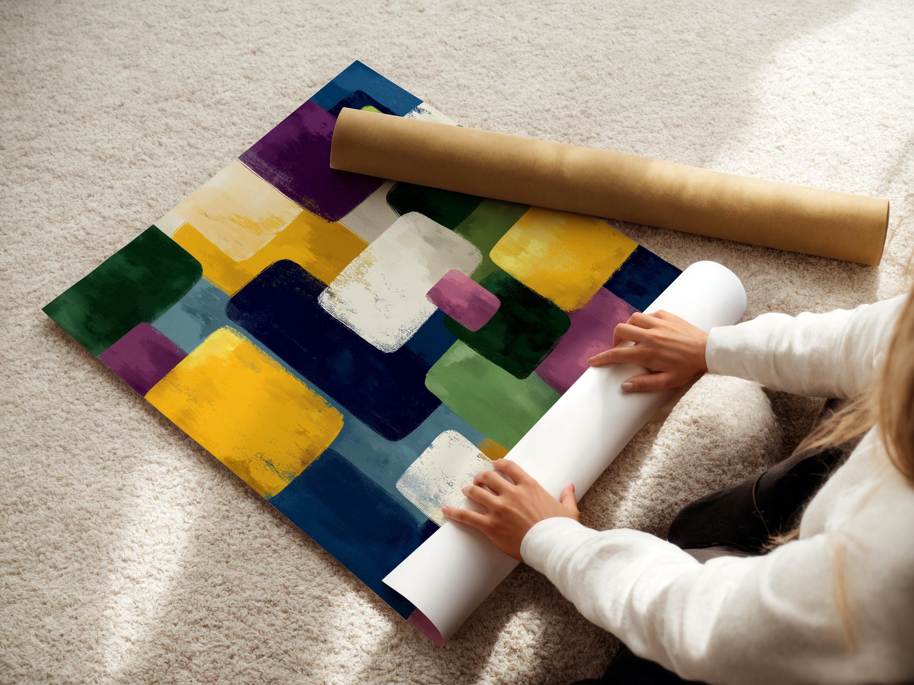 A framed geometric abstract artwork features overlapping colourful blocks—green, yellow, purple, blue and white—arranged in an irregular, layered
