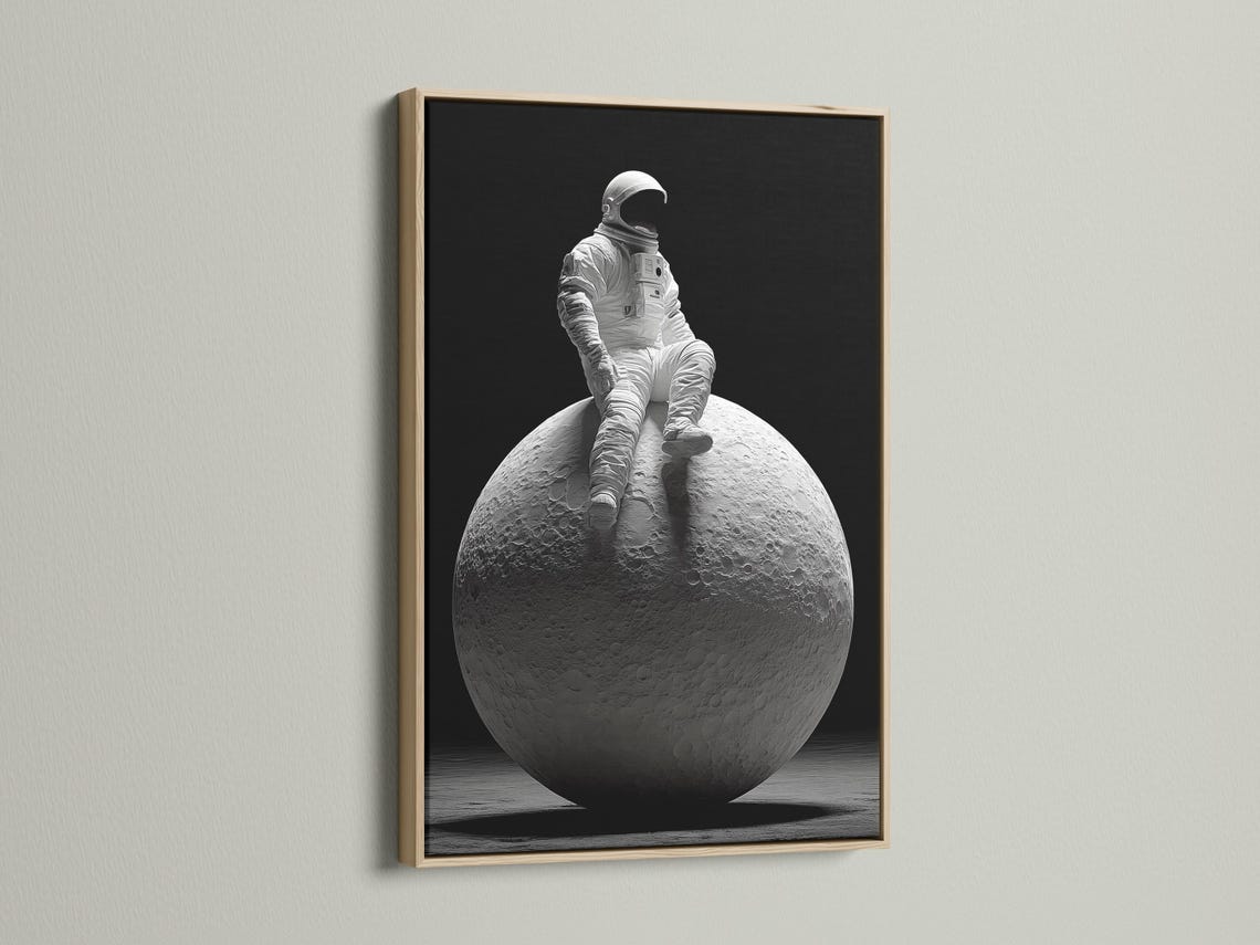 Monochrome astronaut in a space suit seated on a cratered moon against a dark background detail view