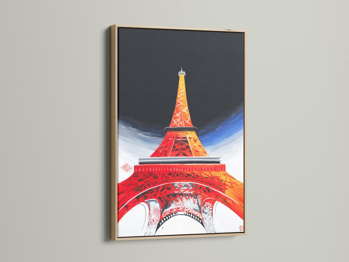 Room mockup showing framed Eiffel Tower artwork in red, orange and blue