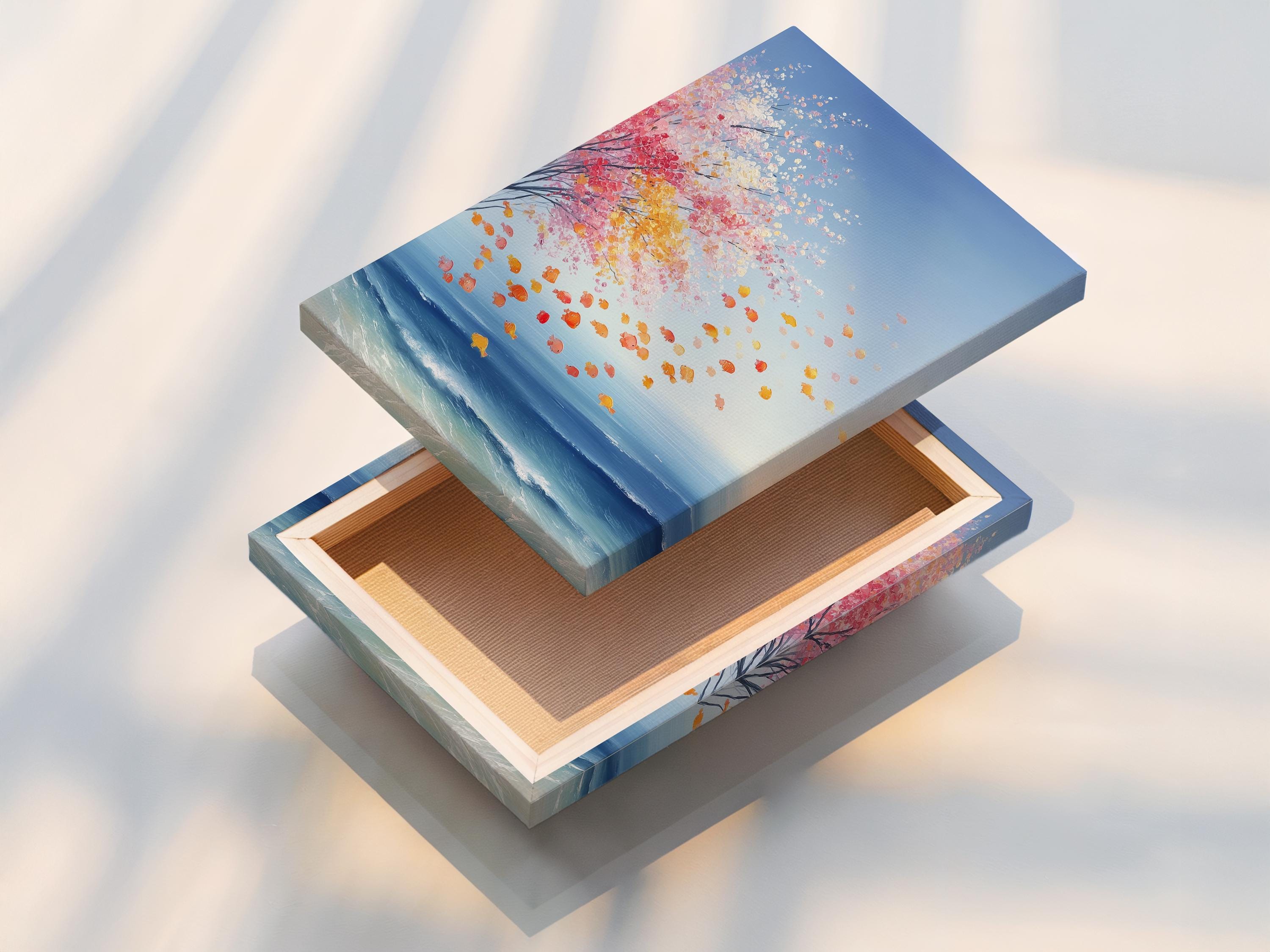 Room mockup showing a framed coastal seascape artwork with pink blossom petals and blue ocean