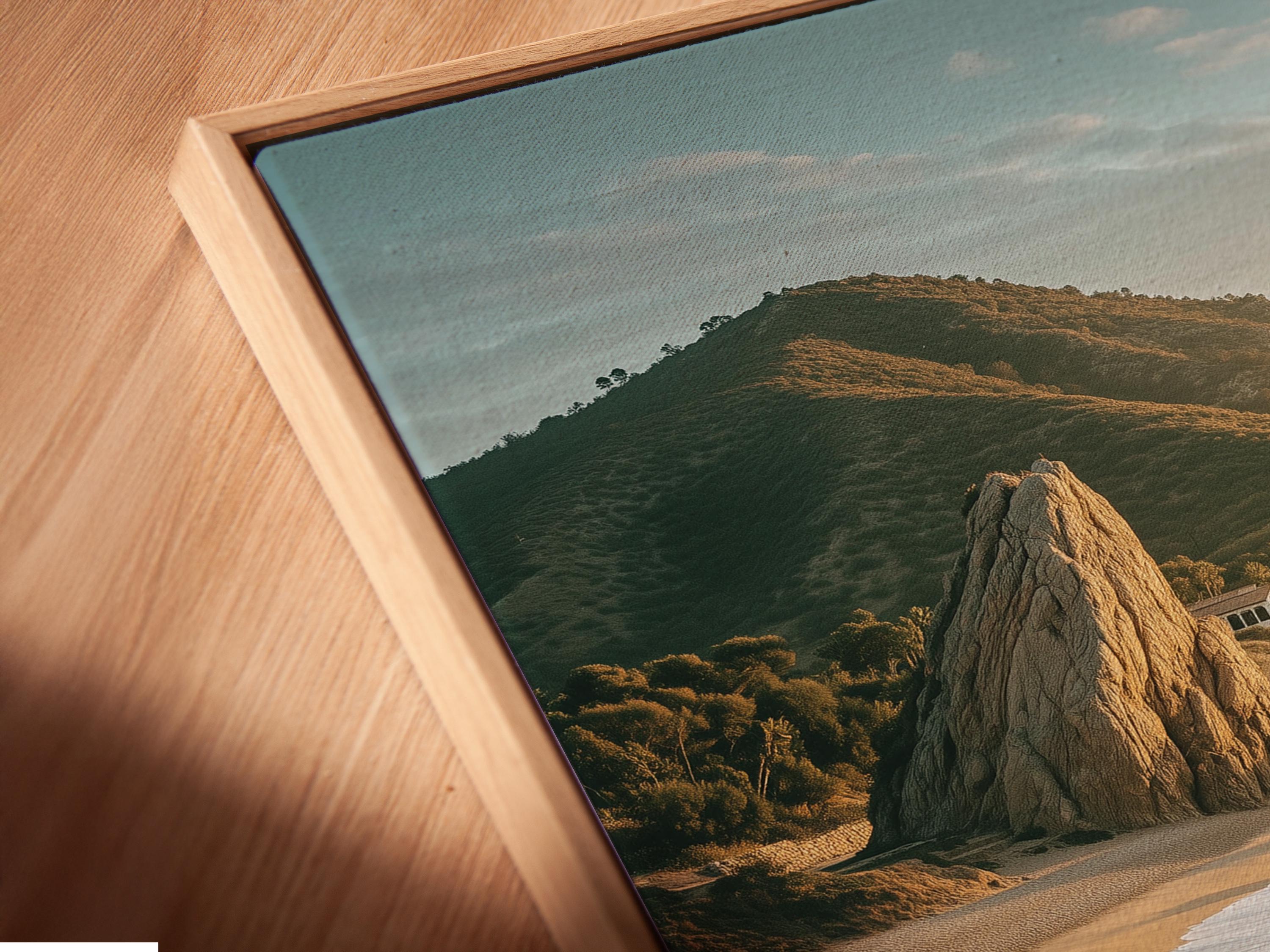 Golden hour seascape showing sandy shore, foamy waves, rocky cliffs and headland detail view