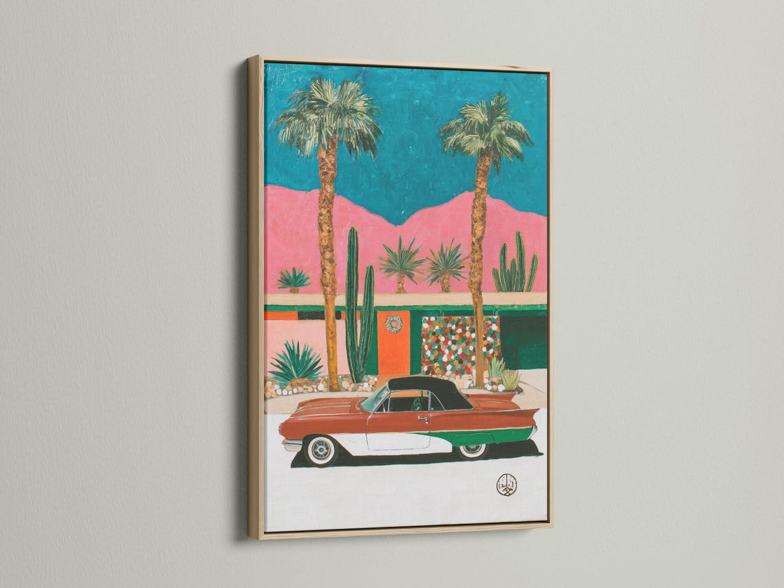 Retro car in a desert scene with palm trees, cacti, and teal and pink background detail view