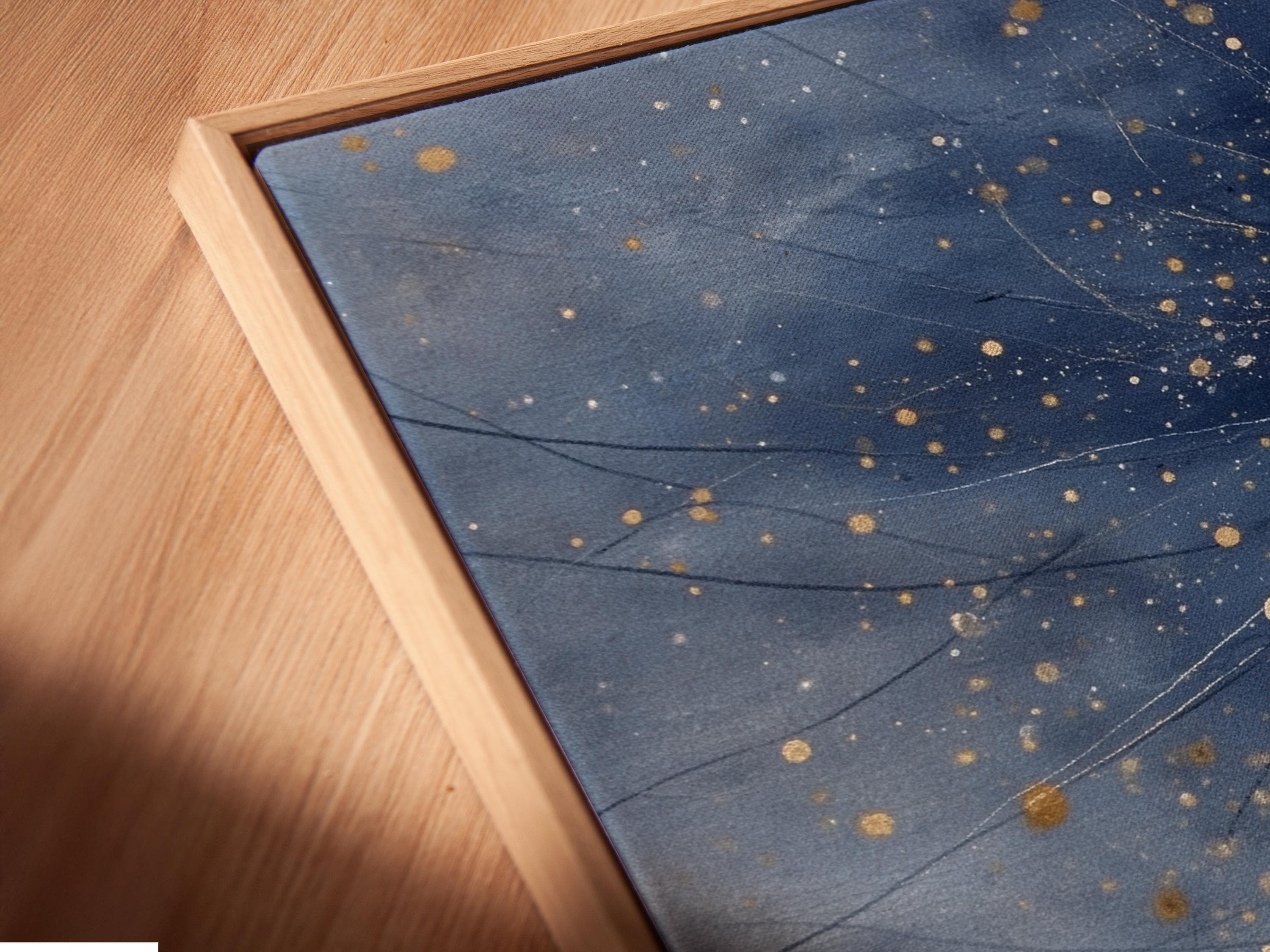 Room mockup showing framed navy blue starry night artwork with golden star dots and cosmic lines