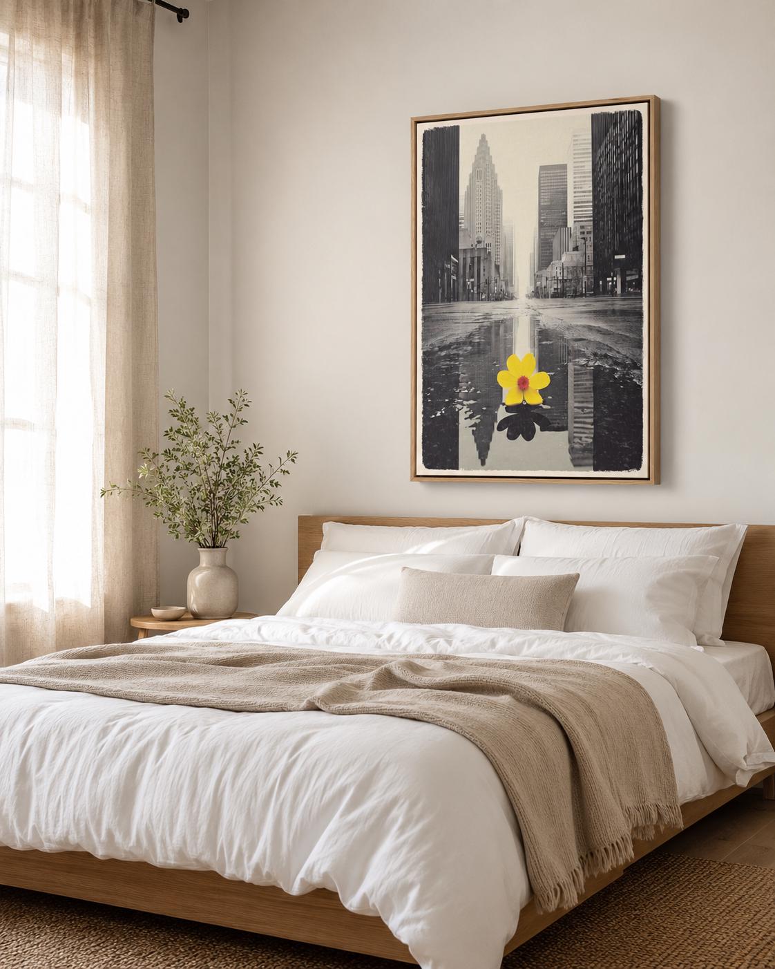 A monochrome city skyline is overlaid with a single bright yellow flower, reflected in water-like bands, creating a high-contrast urban accent detail