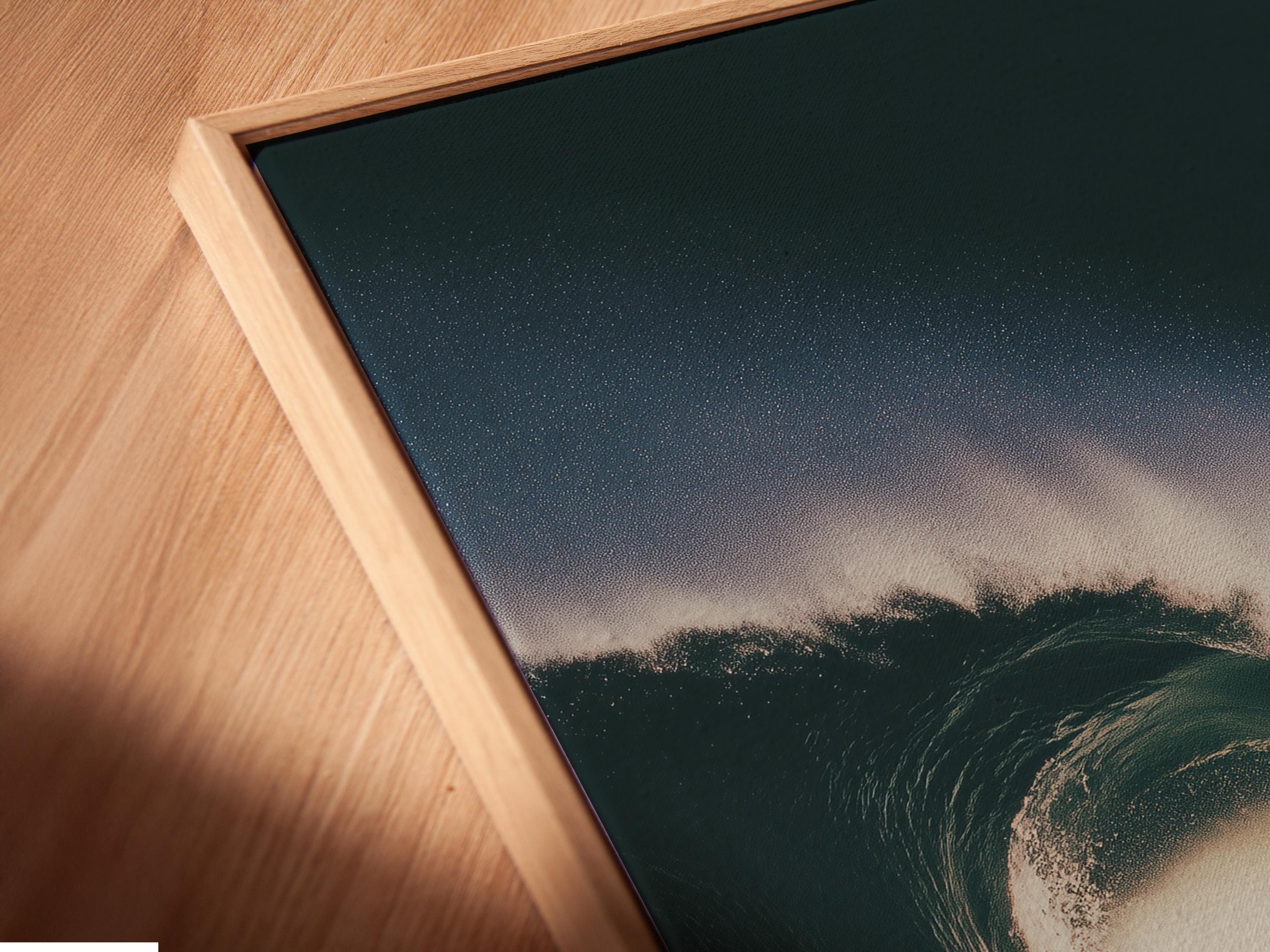 Surfer riding a curling wave, shown in dark teal ocean tones with bright white foam and spray mist detail view