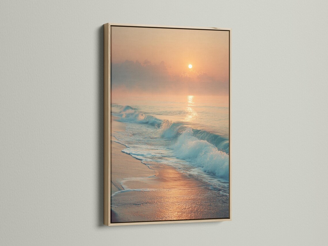 A sunrise seascape shows a glowing sun above layered clouds, with ocean waves rolling onto a sandy shore and reflecting warm light detail view