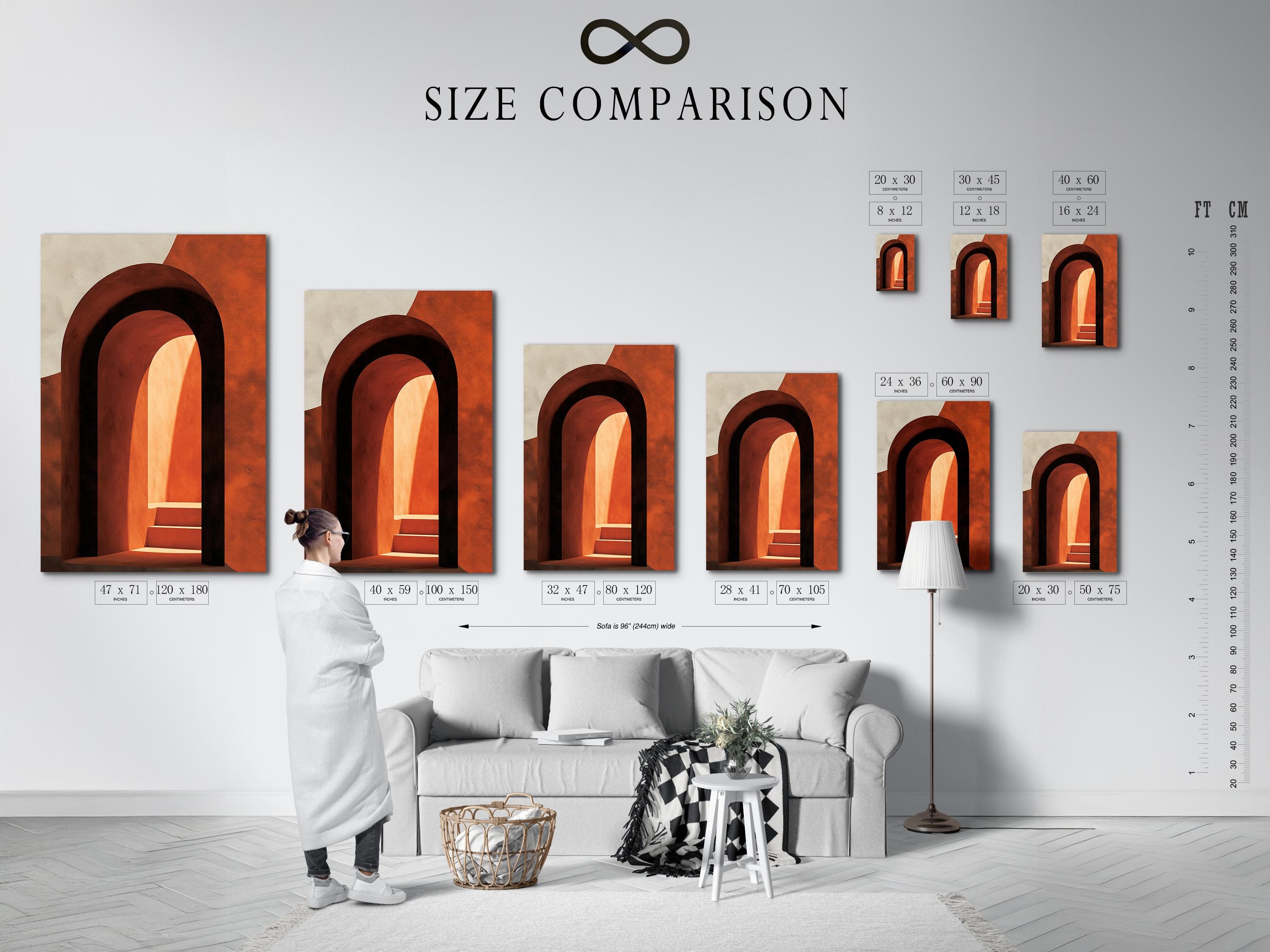 Woman holding a mug standing beside an abstract arch wall artwork in warm terracotta tones