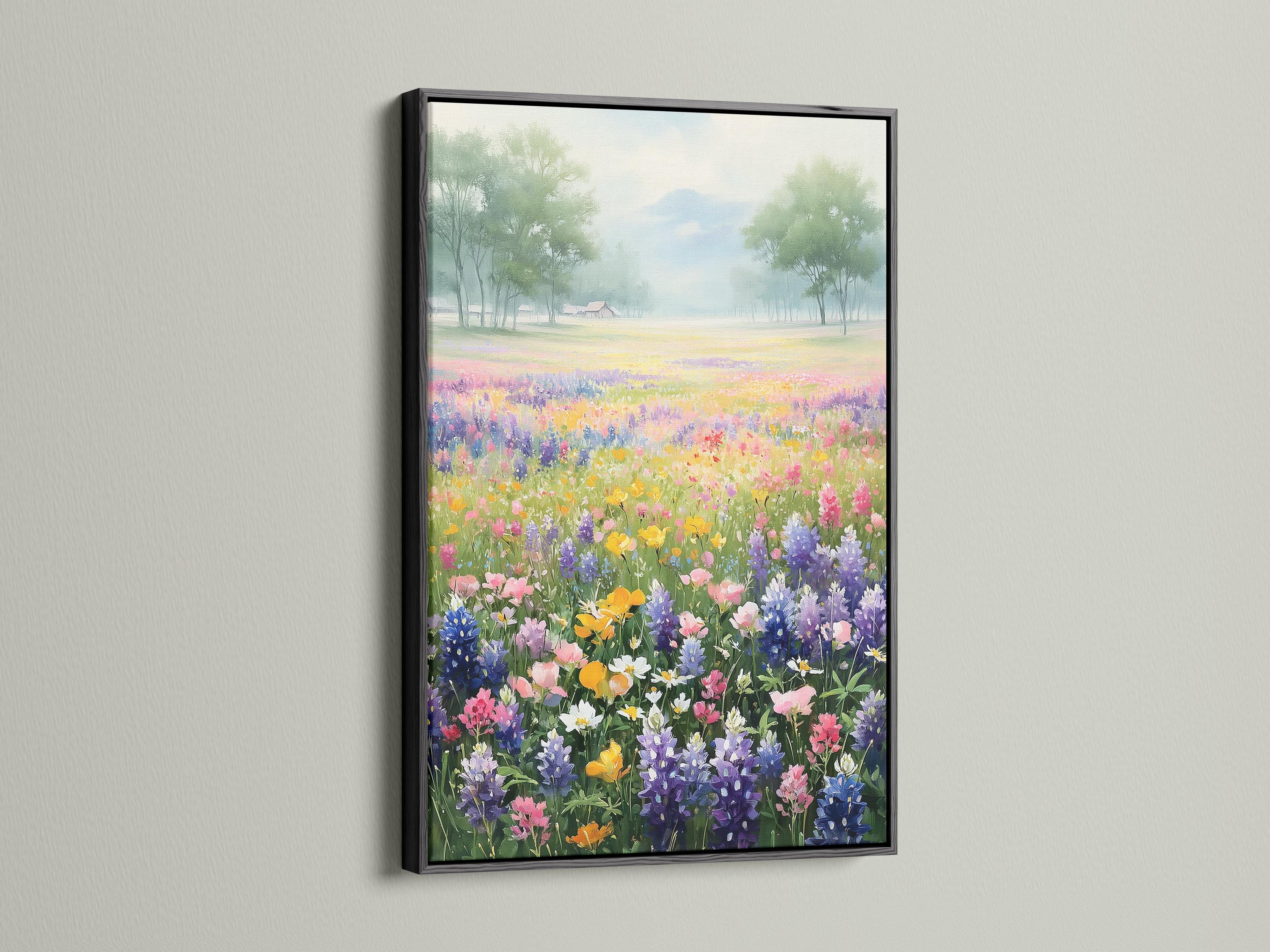 Pastel wildflower meadow with colourful flowers in the foreground and misty trees in the distance detail view