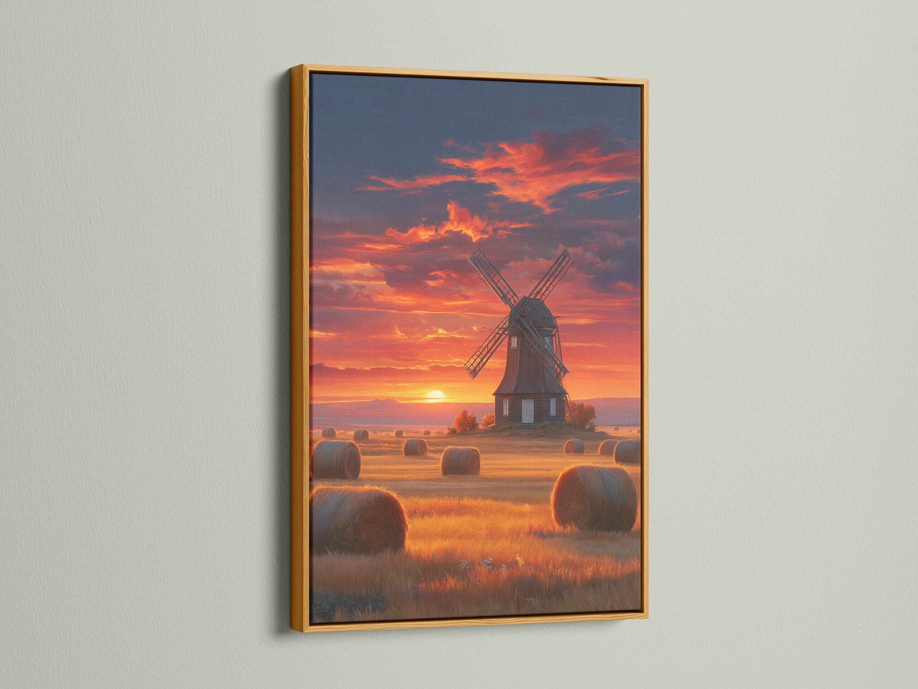 Windmill in a countryside landscape under a glowing sunset sky with hay bales detail view