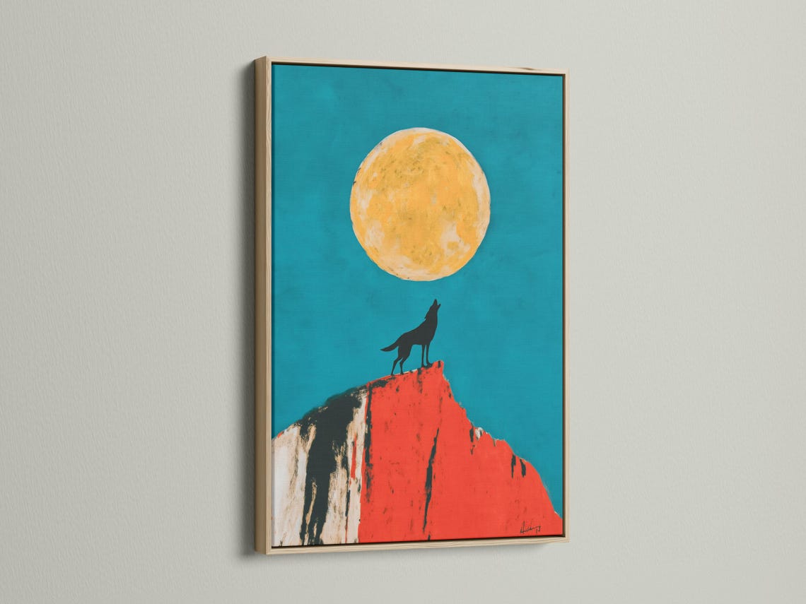 Mockup showing framed wolf moon artwork with a teal background, wolf silhouette and red cliff
