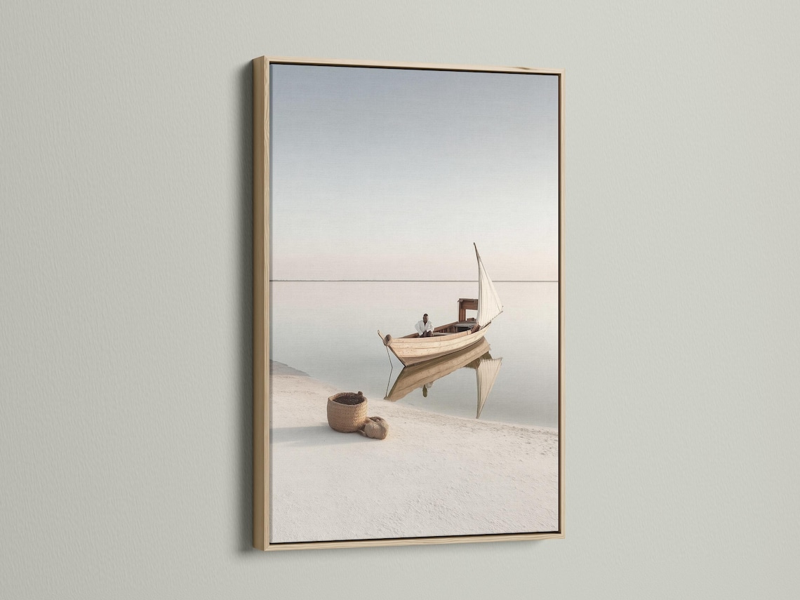 Neutral sailboat seascape with a pale sail on calm water and a hazy horizon detail view