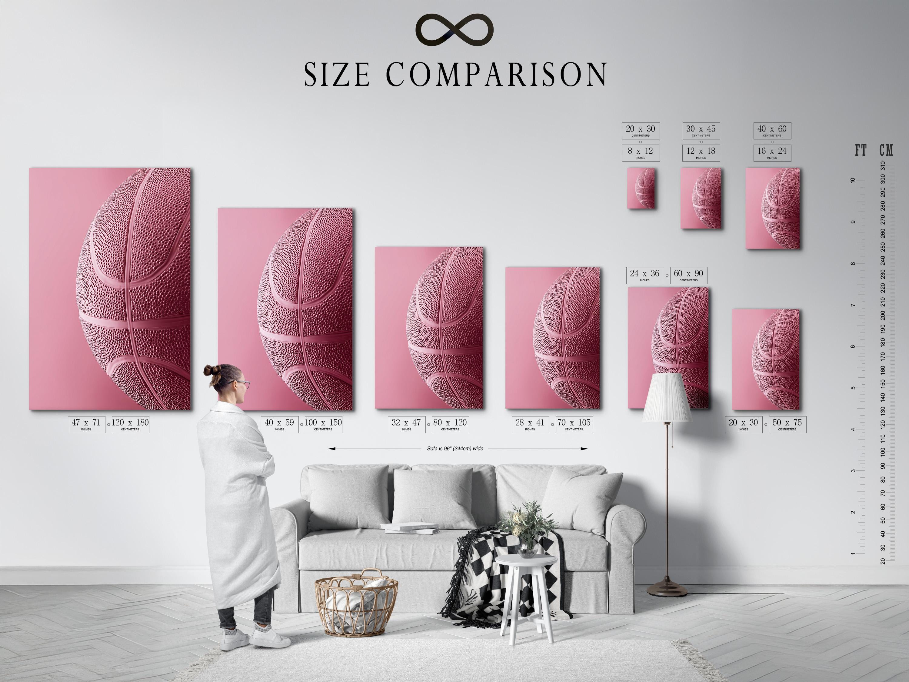 Woman sitting on a sofa beside a framed bubblegum pink basketball artwork