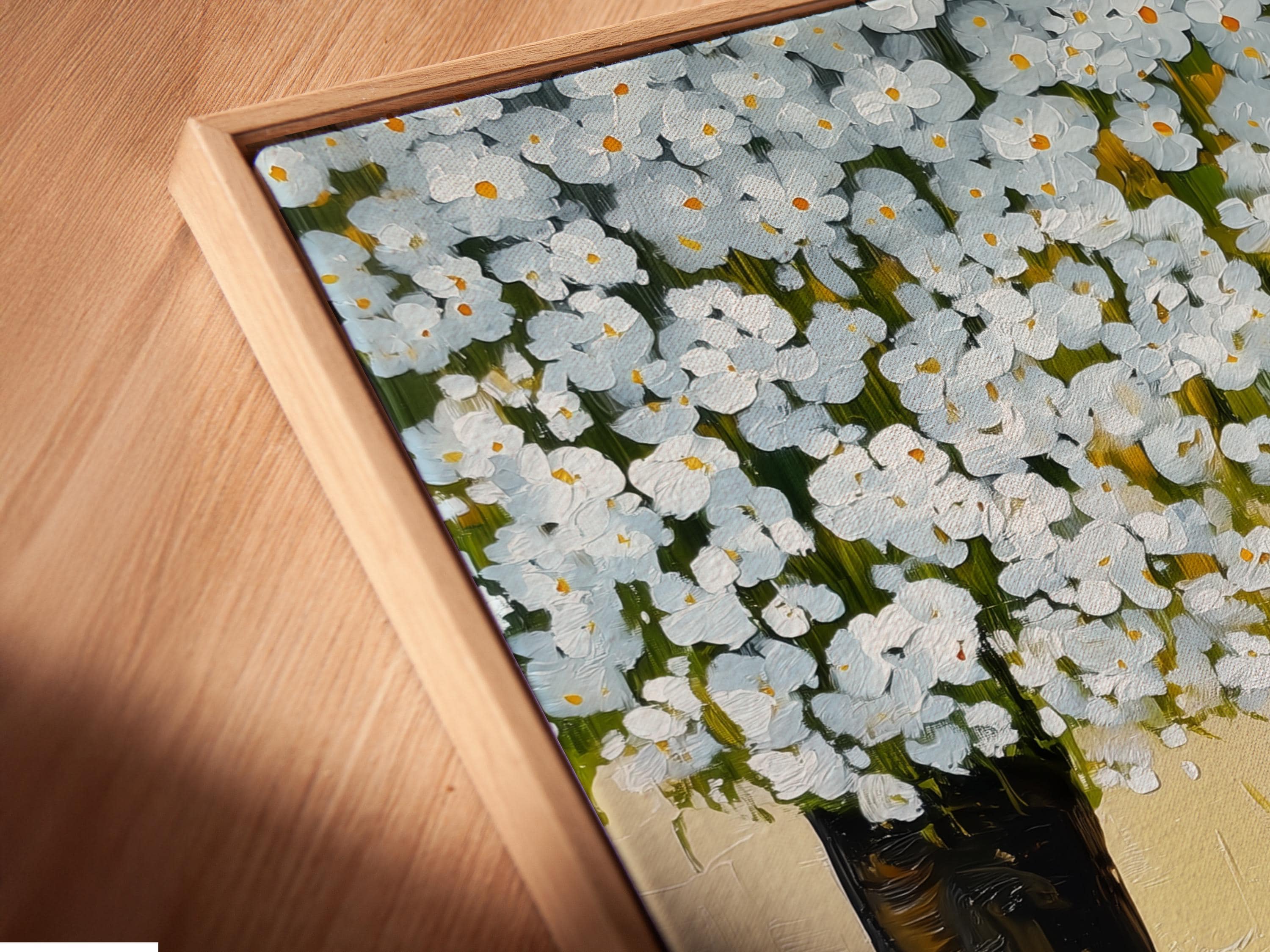 Grey and white cat lying on green grass beneath a tree with white blossoms detail view