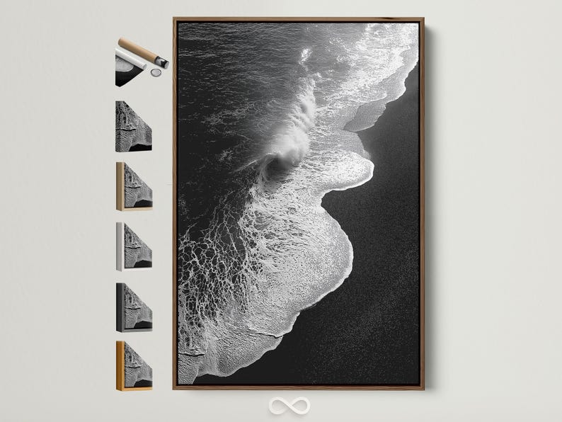 A monochrome seascape shows a foamy wave curling in bright white against deep black water, with a high-contrast, textured finish