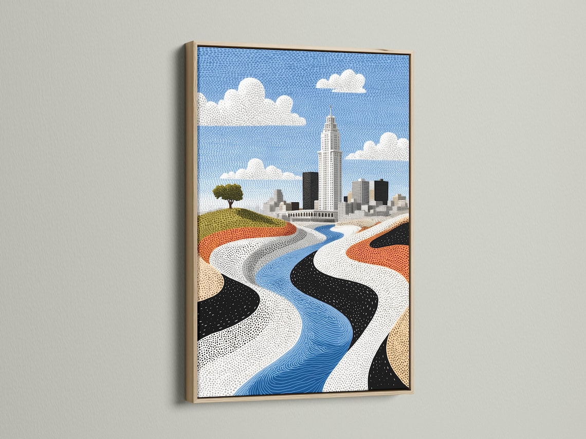 Room mockup showing a framed cityscape artwork with a blue river and skyline