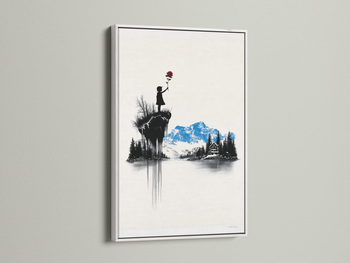 Room mockup showing a framed artwork of a monochrome mountain scene with a girl silhouette holding a red rose