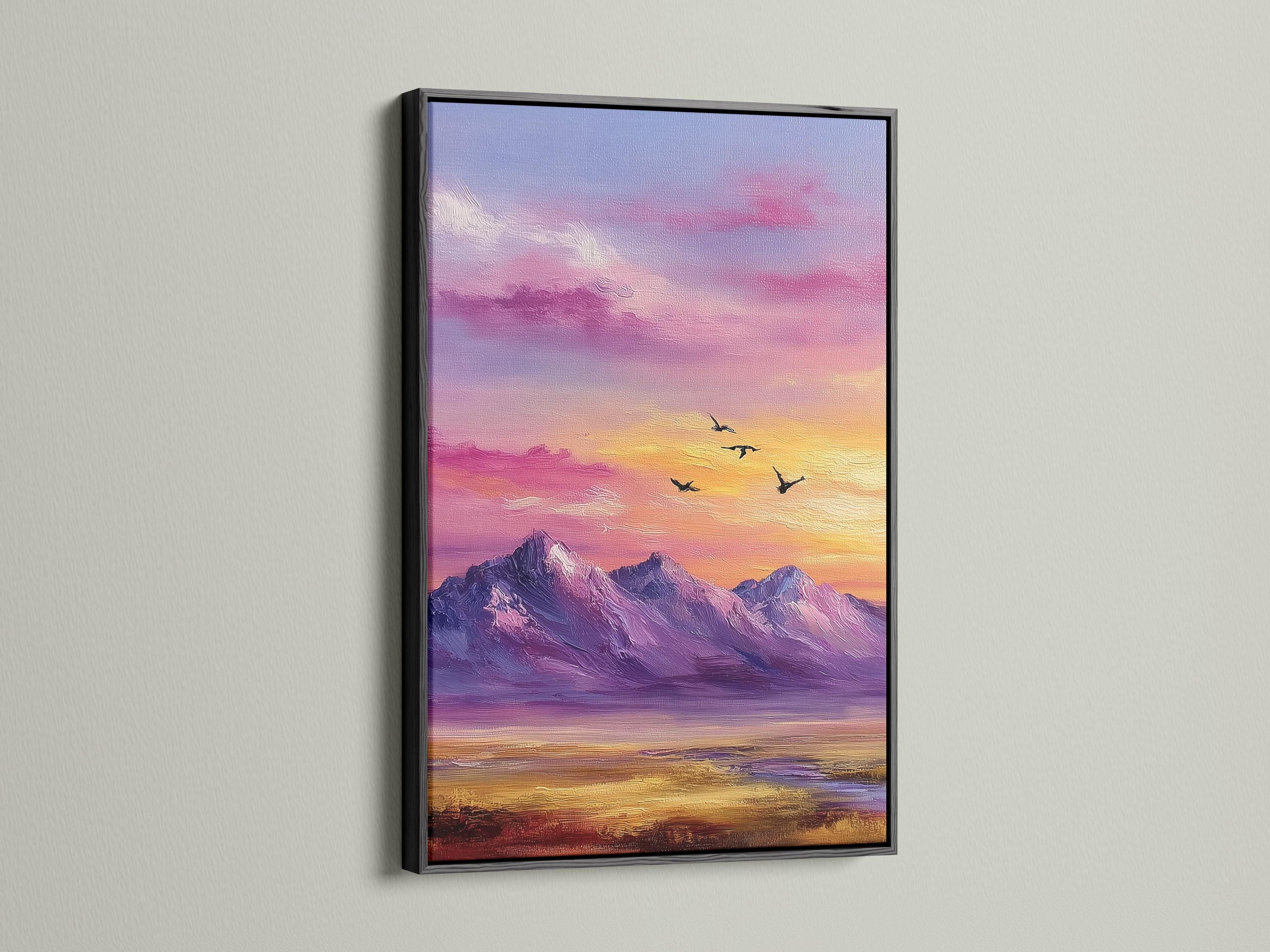 A framed mountain sunset illustration with purple, pink and gold skies and small black birds detail view