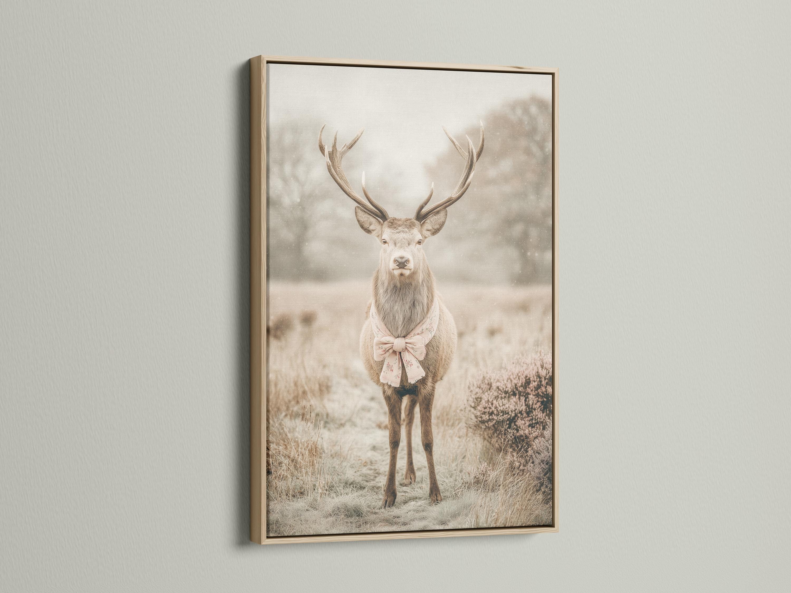 Deer portrait with raised antlers in a misty field, wearing a pale pink bow detail view
