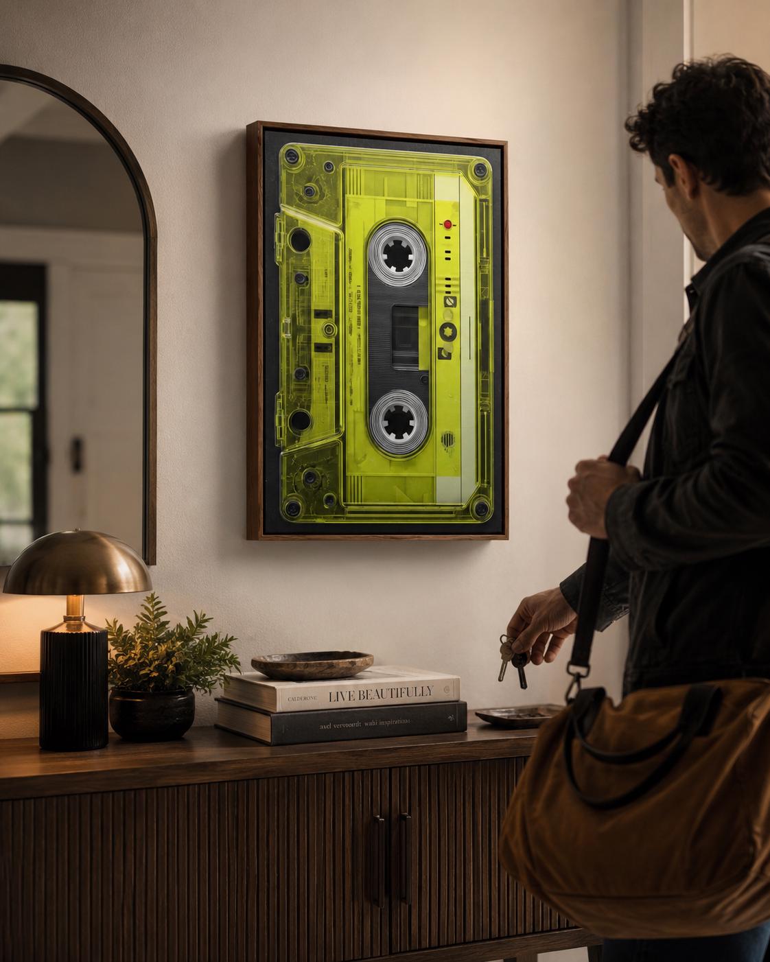 Neon lime cassette tape graphic framed in black with spool circles and a red dot detail detail view
