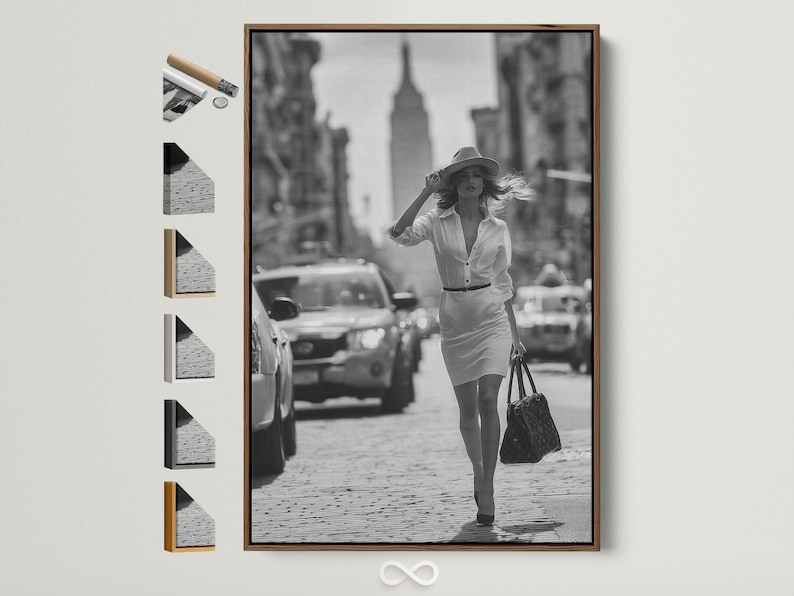 A black-and-white street photograph shows a stylish woman walking forward with a hat and handbag, with blurred city buildings and cars behind her